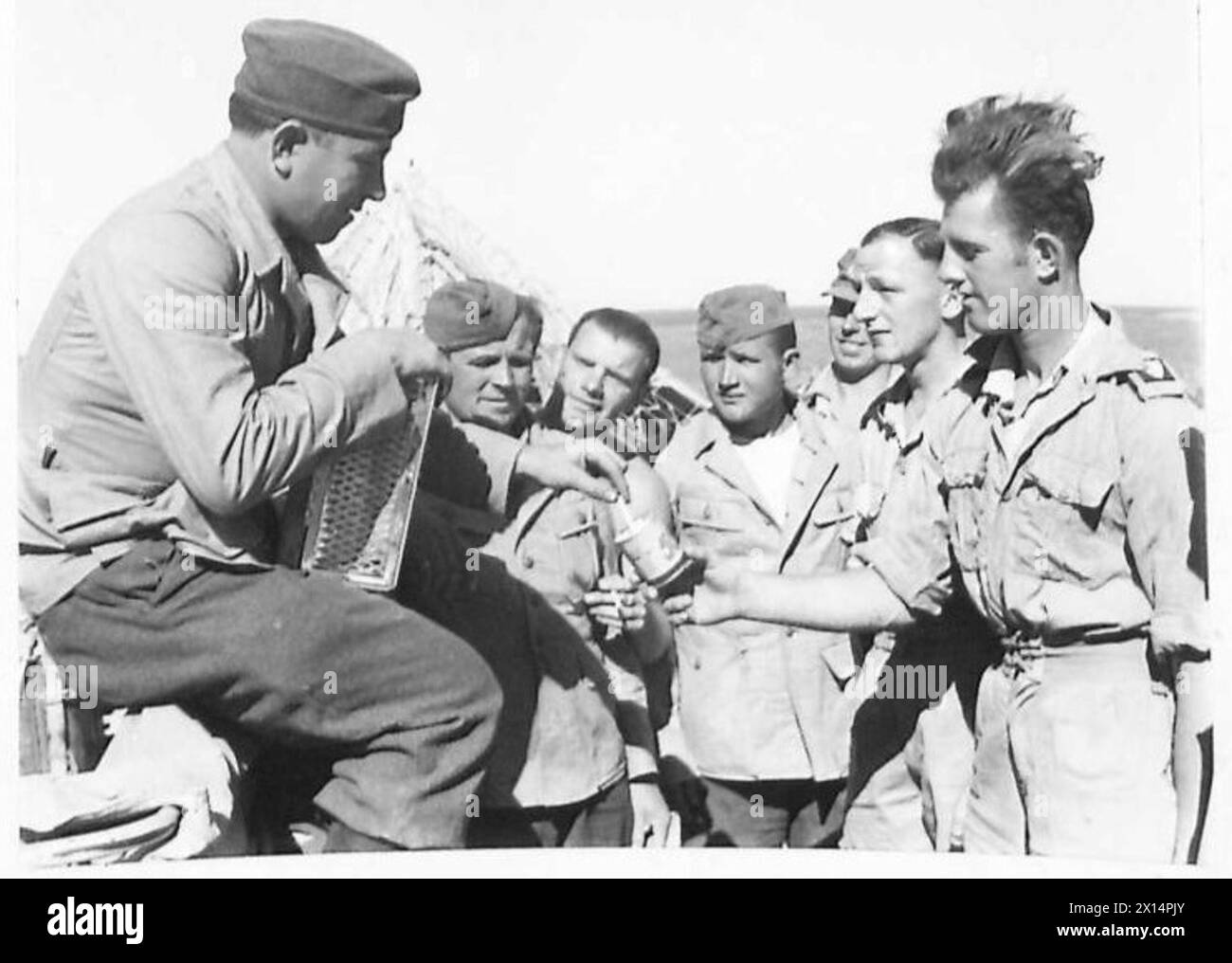 Les soldats britanniques offrent des cigarettes aux soldats russes récemment libérés de l'esclavage nazi lors des opérations de la IIe Guerre mondiale Banque D'Images