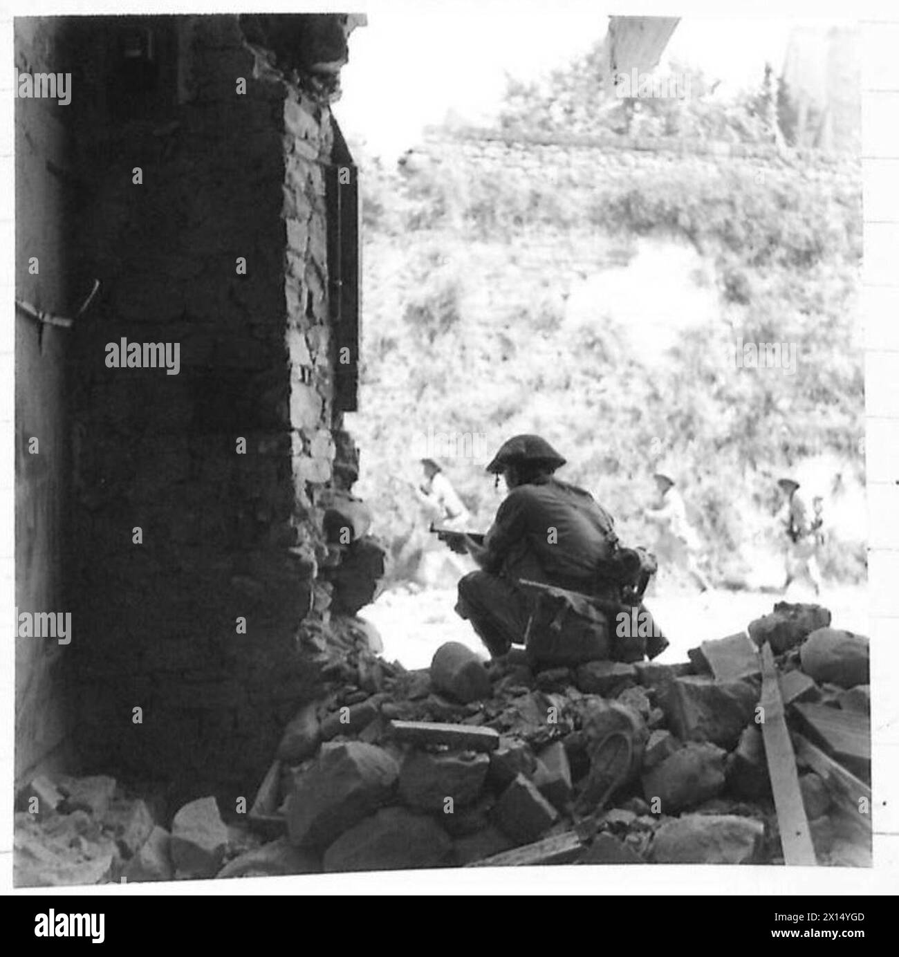 Une patrouille avance pendant la capture de Tavoleto tandis qu'un soldat fournit une couverture avec un canon Tommy Banque D'Images