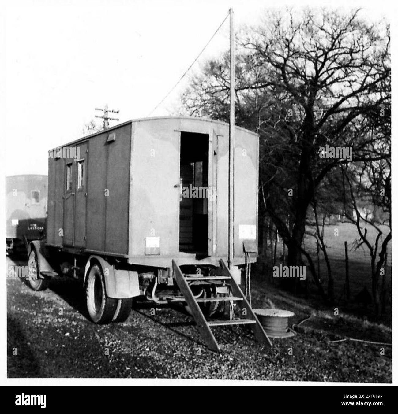Un opérateur de téléphonie mobile de l'armée britannique dont la porte arrière est ouverte affiche le câble pendant les opérations de communication sur le terrain. Banque D'Images