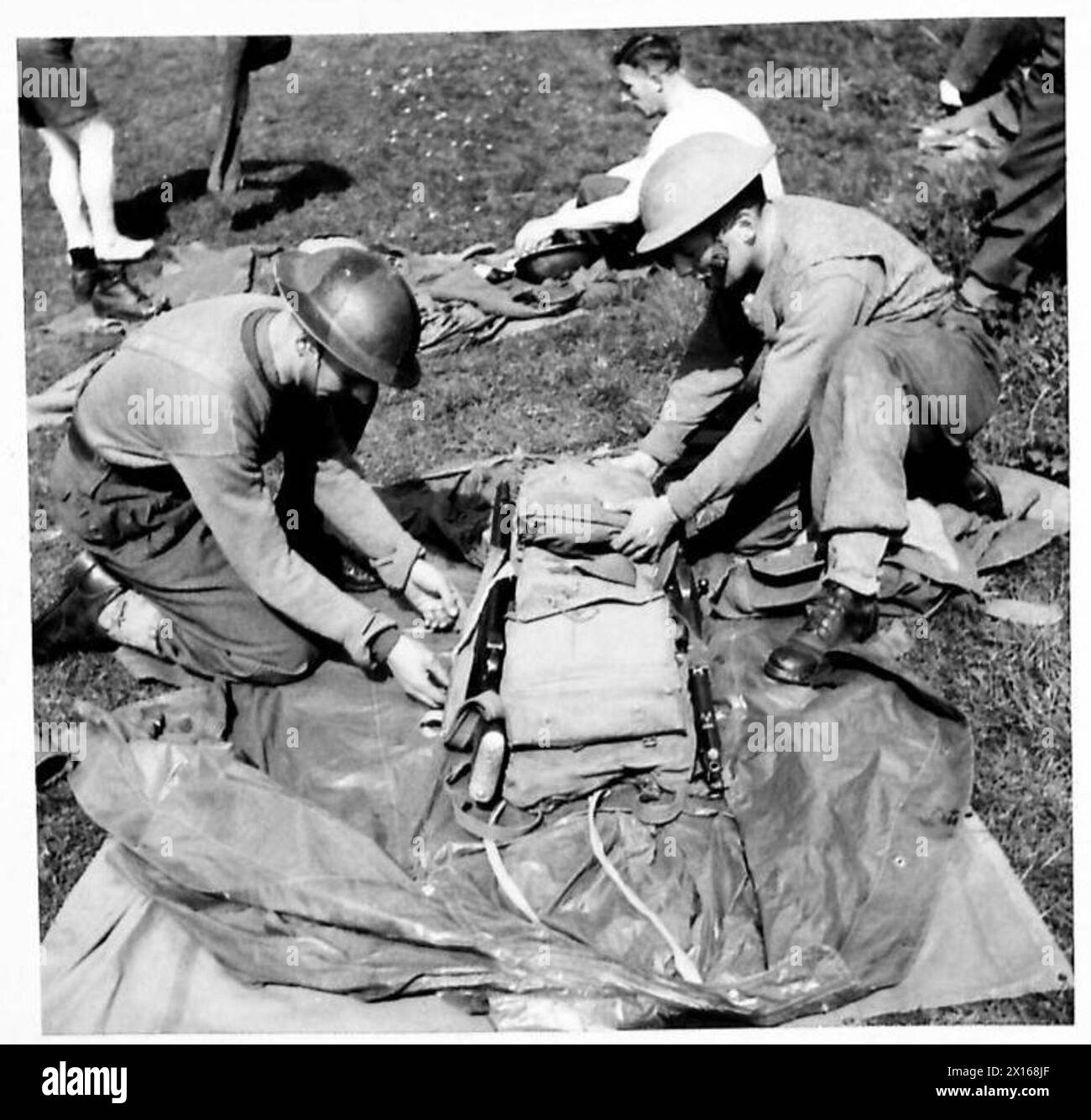 Deux soldats emballent leurs fusils et leur équipement dans le cadre d'un exercice de franchissement de rivière de style nouveau, démontrant la préparation militaire et l'état de préparation opérationnelle. Banque D'Images