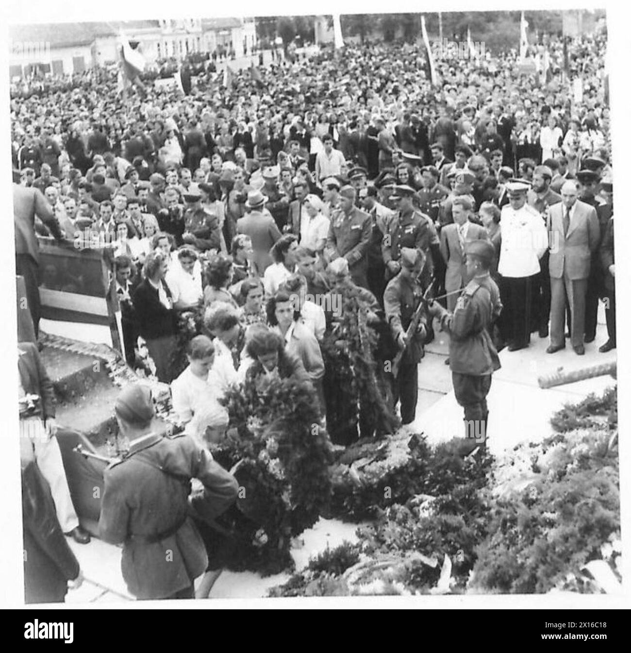 Les participants yougoslaves déposent des couronnes et des fleurs lors du dévoilement des monuments de guerre russes et yougoslaves, observés par le personnel de l'armée britannique. Banque D'Images