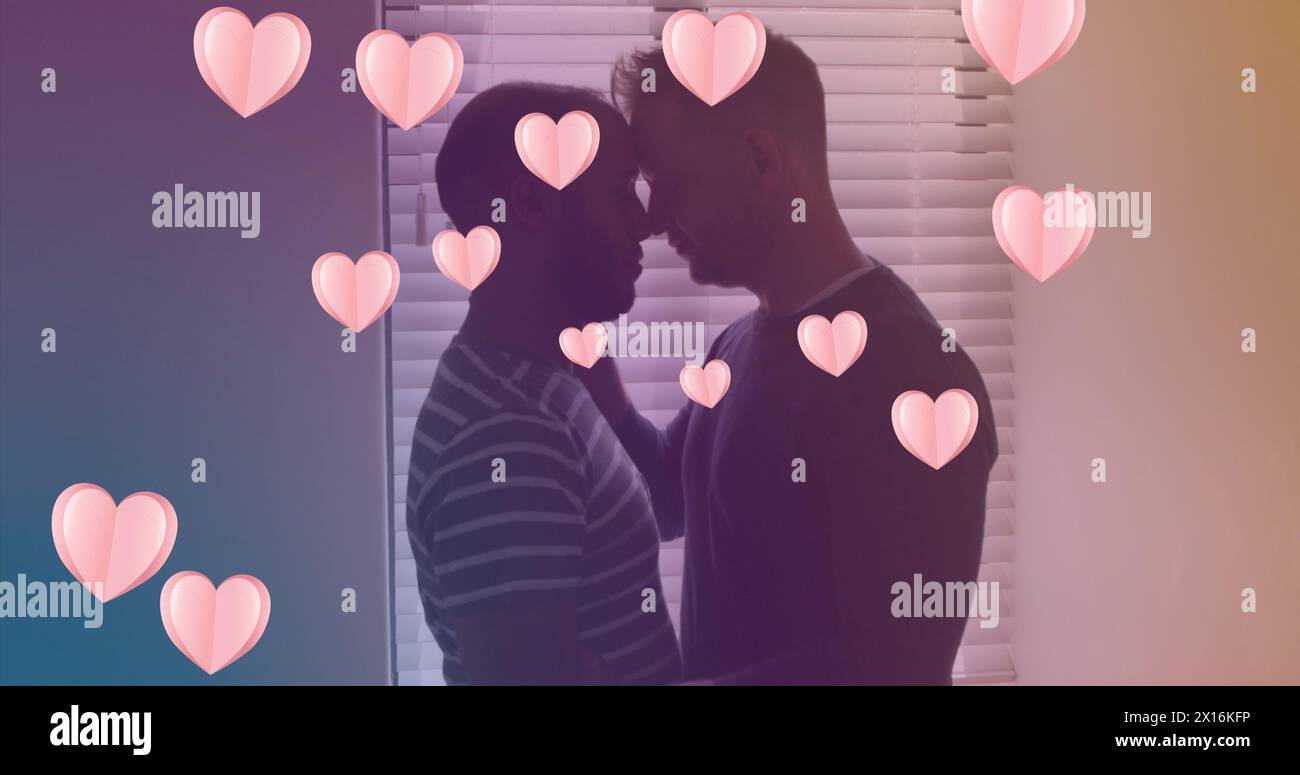 Image d'icônes de coeur sur un couple gay diversifié embrassant. image générée numériquement par le mois de la fierté et le concept de célébration. Banque D'Images