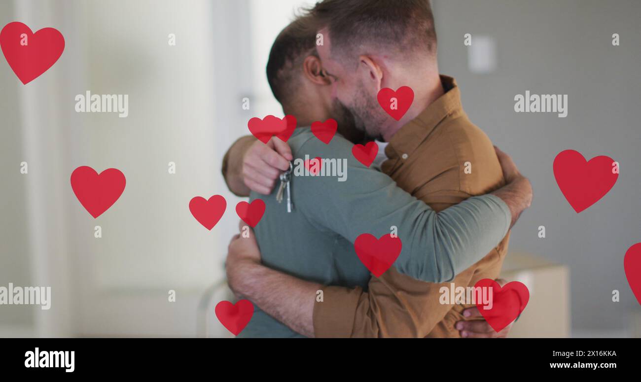 Image d'icônes de coeur sur un couple gay diversifié embrassant Banque D'Images