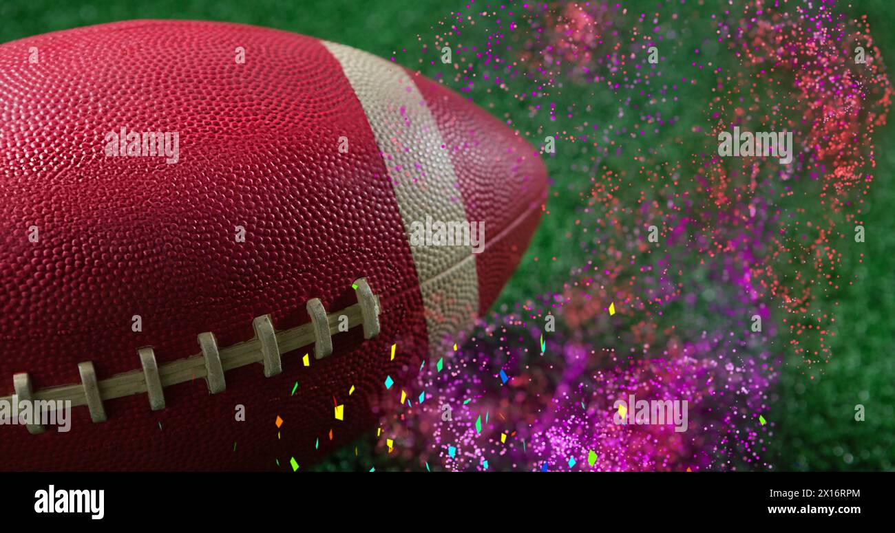 Image de grenaillage de confettis multicolores et motif abstrait sur ballon de rugby sur terrain vert Banque D'Images