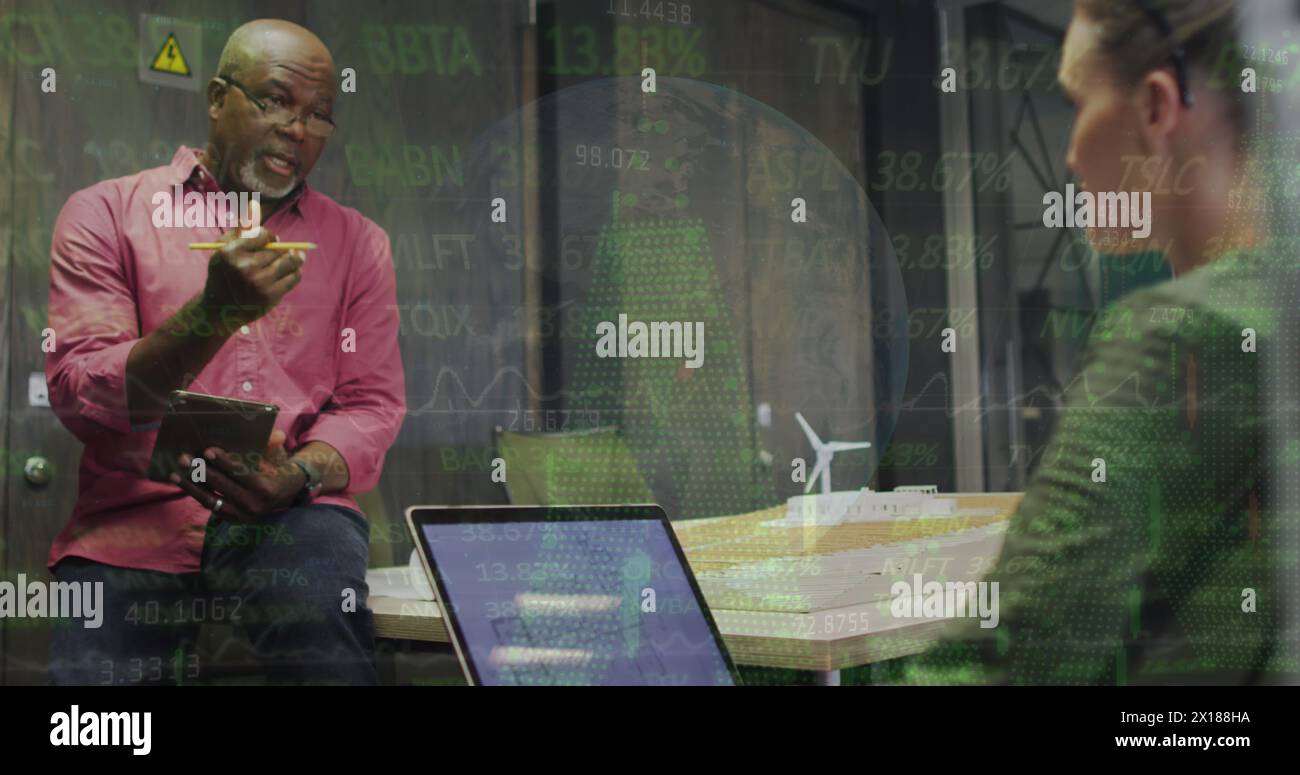 Image de divers collègues discutant des plans sur ordinateur portable contre le globe, les graphiques et la table de négociation Banque D'Images