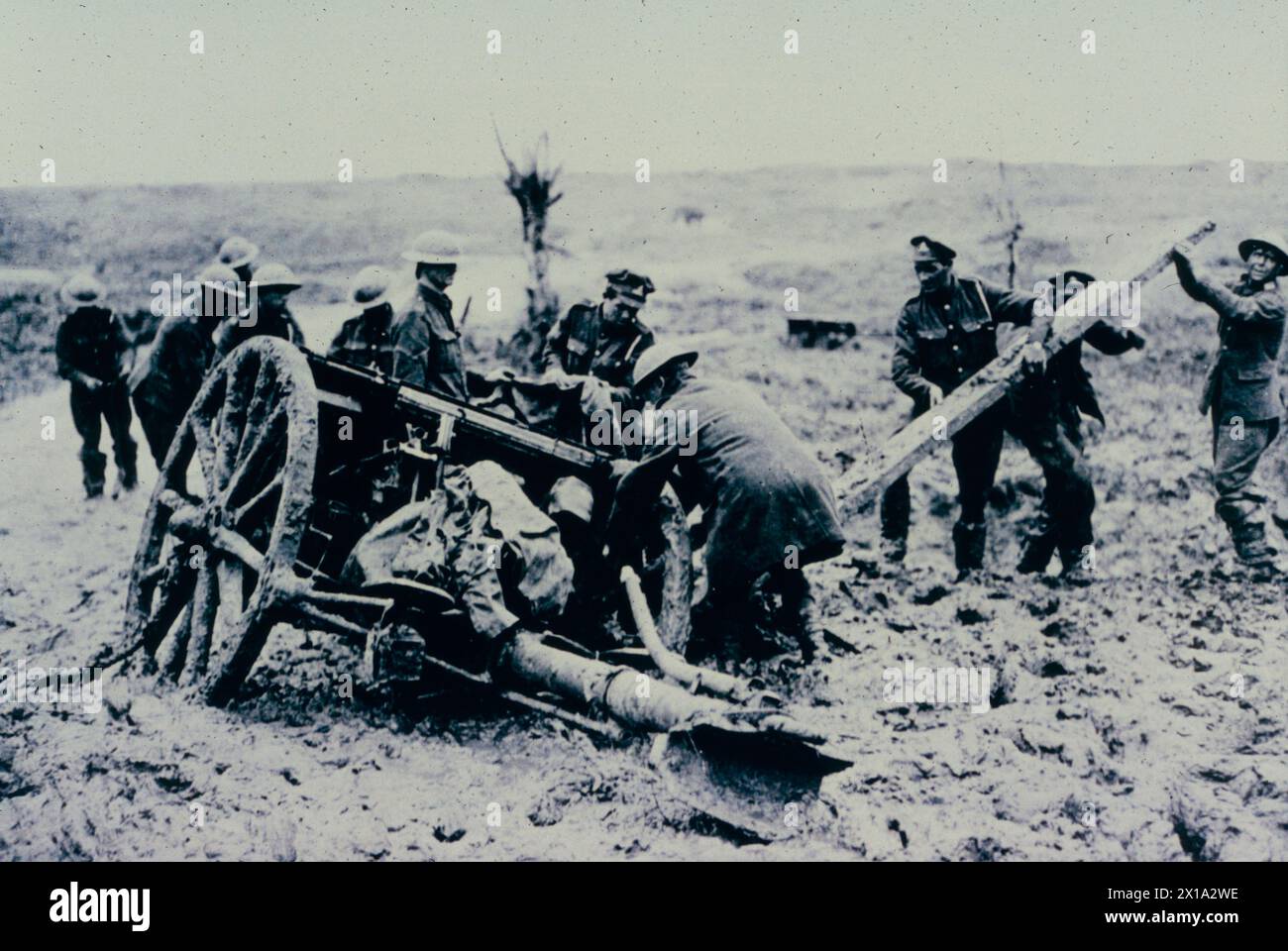 Les soldats britanniques tirent un canon de campagne de la boue, front de Flandre, WW1 1916 Banque D'Images