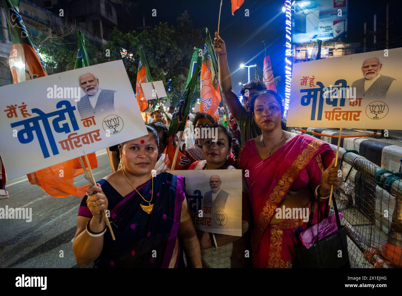 Des partisans du Bharatiya Janata Party (BJP) tenant une pancarte alors qu'ils attendaient la tournée de Narendra Modi, lors d'une campagne électorale à Guwahati, Assam, Inde, le 16 avril 2024. Crédit : David Talukdar/Alamy Live News Banque D'Images