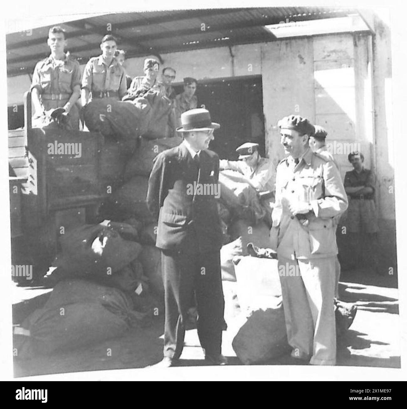SECRÉTAIRE D'ÉTAT À LA GUERRE EN AFRIQUE DU NORD - au bureau de poste de l'armée, Sir James discute avec un officier pendant que le courrier est déchargé d'un camion en arrière-plan, l'armée britannique Banque D'Images