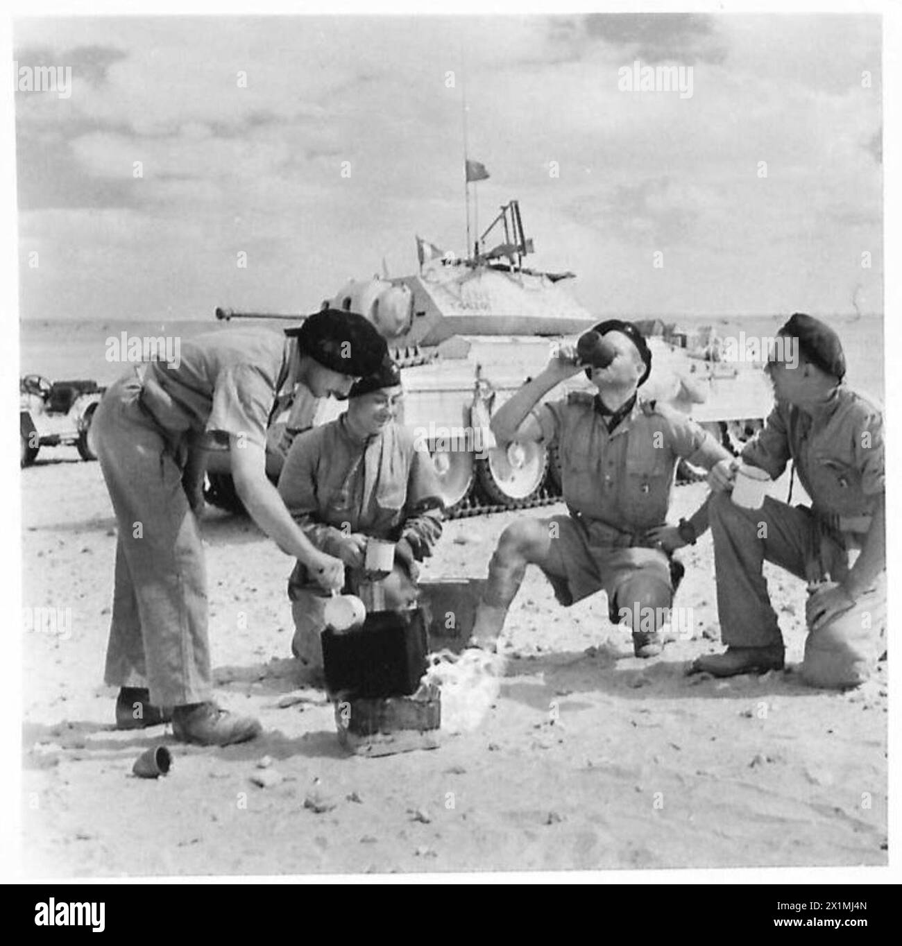 Un équipage de chars de la Free French Flying Column fait une pause dans le désert pour préparer du thé, démontrant la vie quotidienne et les routines du personnel militaire pendant les opérations dans le désert. Banque D'Images
