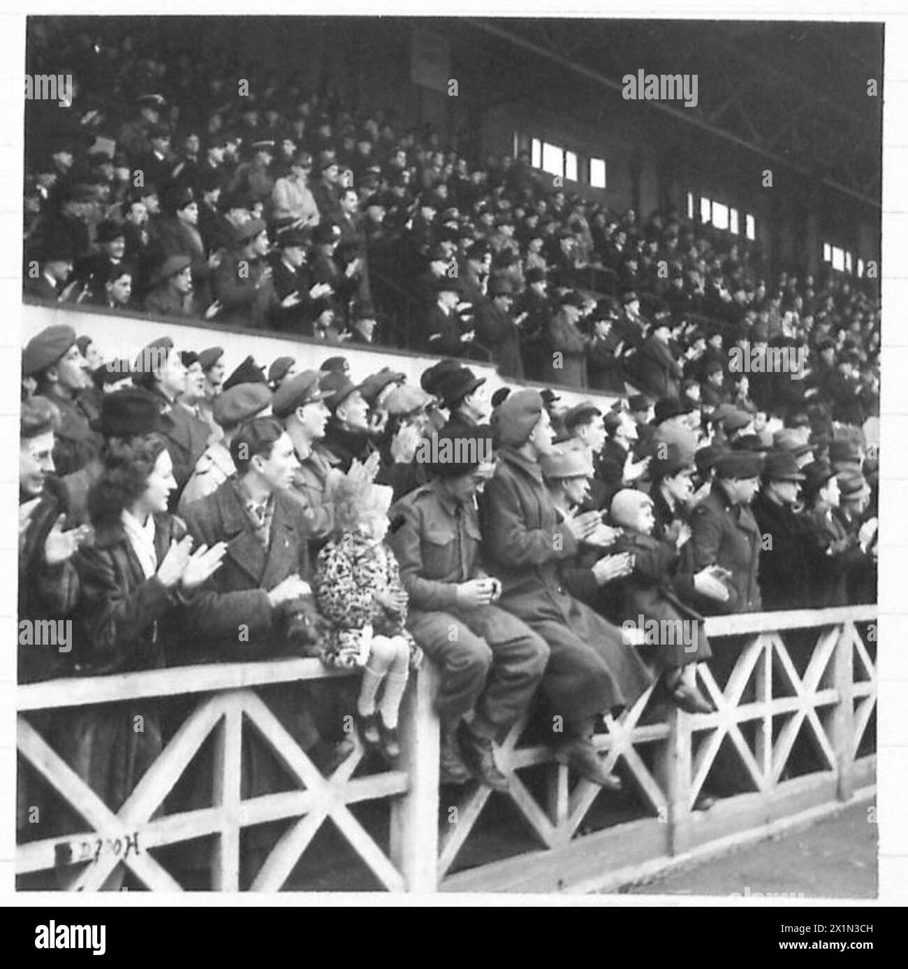 Les spectateurs regardent un match de football à Bruxelles le jour de l'Armistice, applaudissant la pièce tandis que le personnel de l'armée britannique observe le 21e groupe d'armées. Banque D'Images
