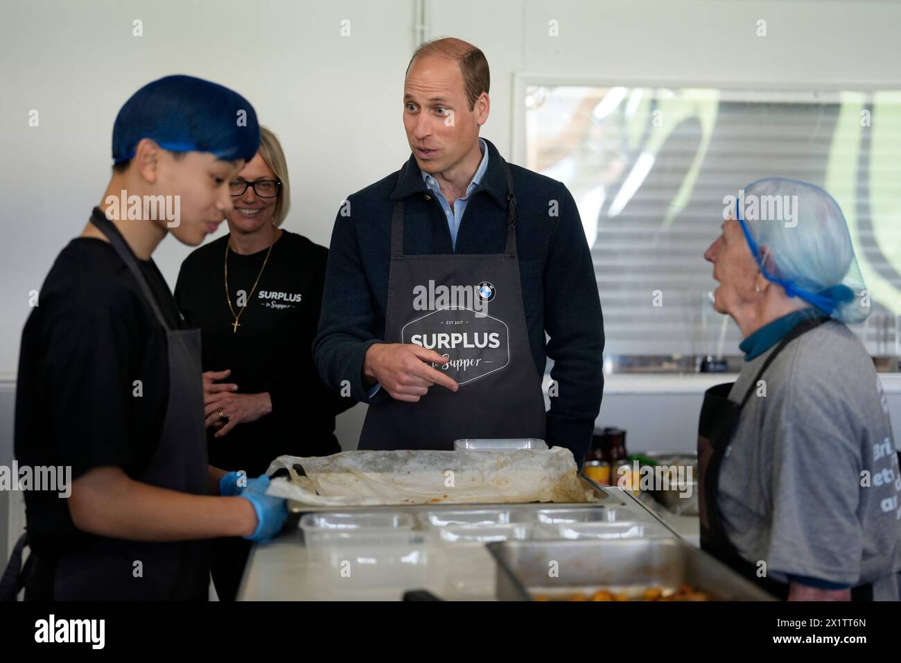Britain's Prince William meets workers during a visit to Surplus to Supper, in Sunbury-on-Thames, Surrey, England, Thursday, April 18, 2024. The Prince visited Surplus to Supper, a surplus food redistribution charity, to learn about its work bridging the gap between food waste and food poverty across Surrey and West London. (AP Photo/Alastair Grant, pool) Banque D'Images