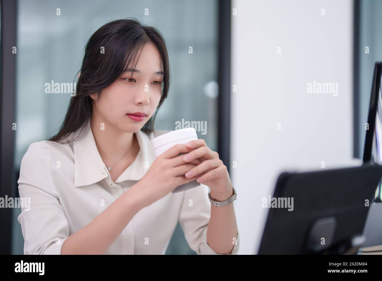 Investisseur femme d'affaires buvant du café chaud et lisant des données pour vérifier le stock d'affaires tout en travaillant sur le stock et le marketing de la nouvelle startup à l'analy Banque D'Images