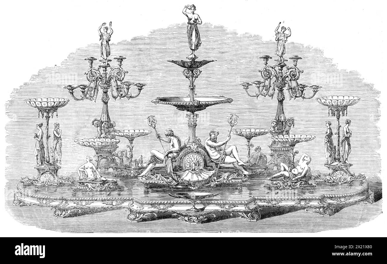 Témoignage à Mr. W. Jackson, de Birkenhead, des actionnaires du chemin de fer de Florence et Pistoja [Pistoia], 1865. 'Un magnifique service de dessert en argent... fabriqué par Mr. Joseph Mayer... pour présentation au Mr. William Jackson, député du South Derbyshire... le cadeau se compose d'un plateau... orné de couronnes de laurier ; sur celui-ci se dresse une très belle pièce maîtresse, avec six stands de fruits et deux stands de fleurs. La pièce centrale agit comme une fontaine d'eau de rose, et, par une contrivance mécanique dans le corps de la pièce, l'eau est amenée à s'écouler de la cruche dans la tasse tenue par une figure de Banque D'Images