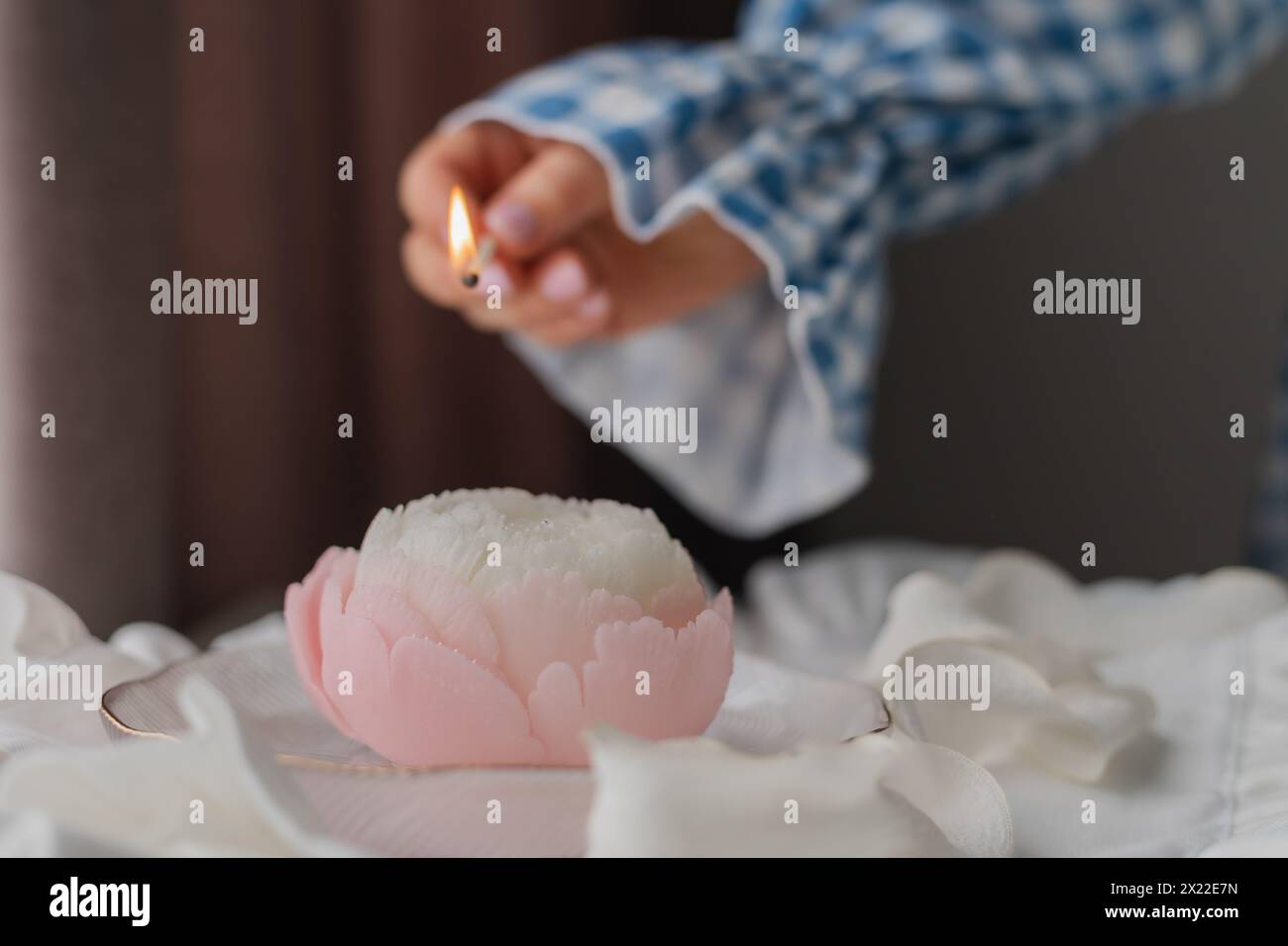 Gros plan d'une femme allumant une bougie à la maison. Photo de haute qualité Banque D'Images