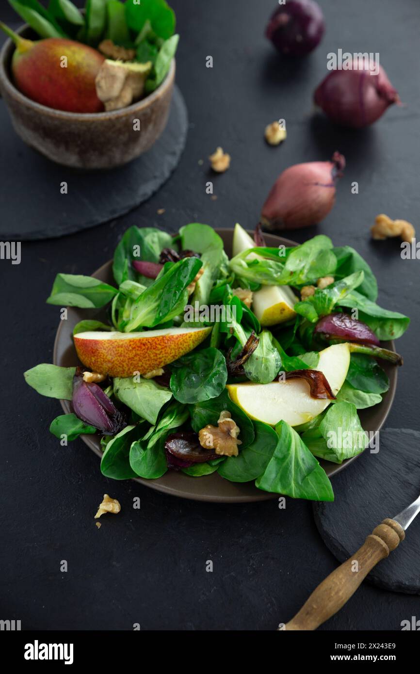 Salade d'automne avec laitue d'agneau, poires et oignons caramélisés Banque D'Images