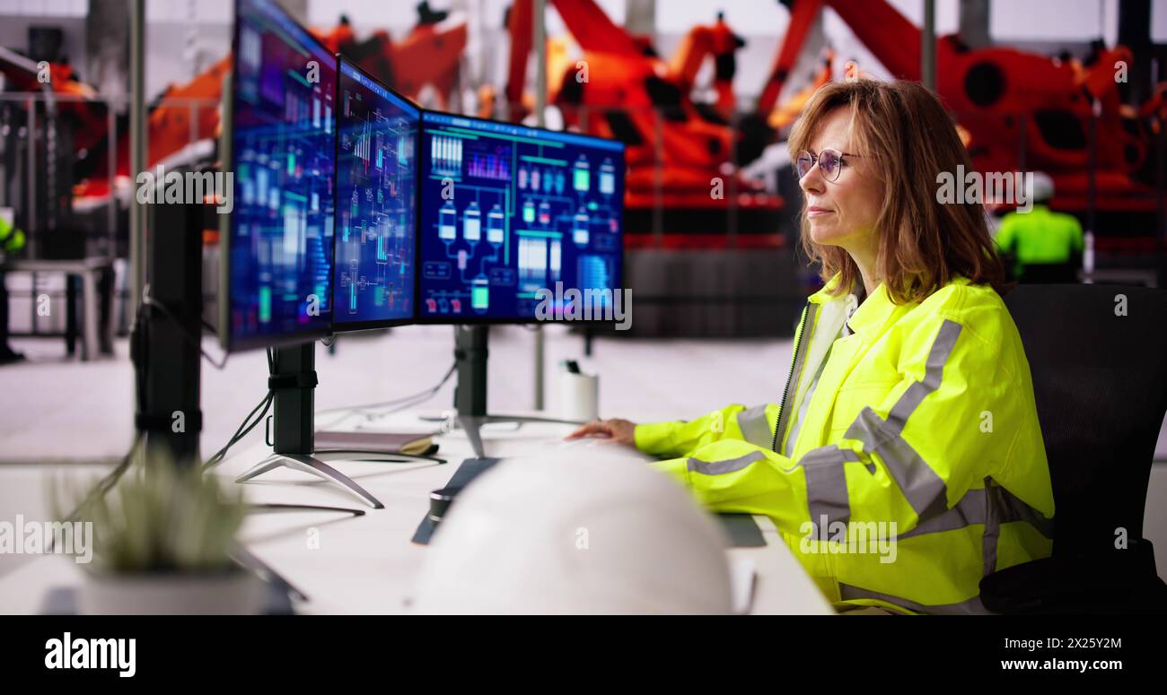 Hommes dans l'usine de voiture automobile utilisant le système SCADA Banque D'Images Hommes dans l'usine de voiture automobile utilisant le système SCADA Banque D'Images
