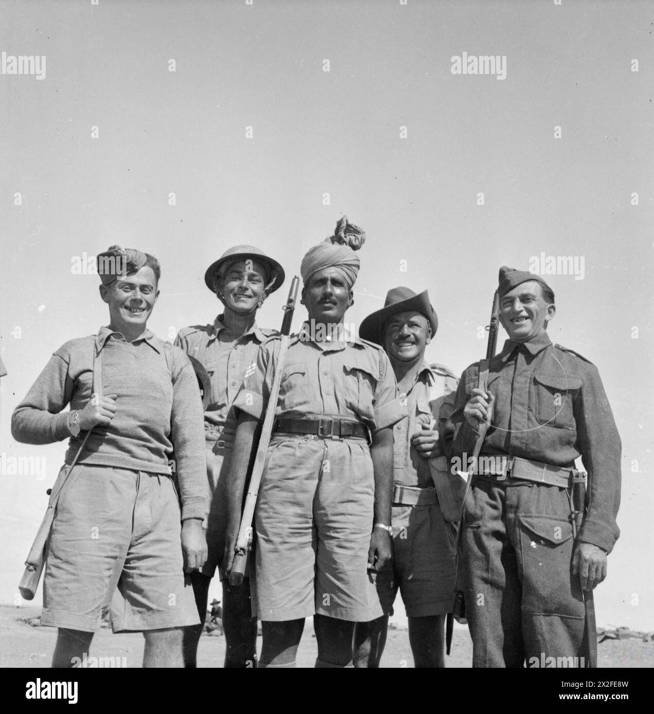Des soldats polonais, britanniques, indiens, australiens et tchèques se rassemblent à Tobrouk le 22 octobre 1941 lors du siège de Tobrouk, combattant les forces allemandes. Le soldat polonais appartient à la Brigade indépendante des Carpates et le soldat tchèque au 11e bataillon d'infanterie. Banque D'Images