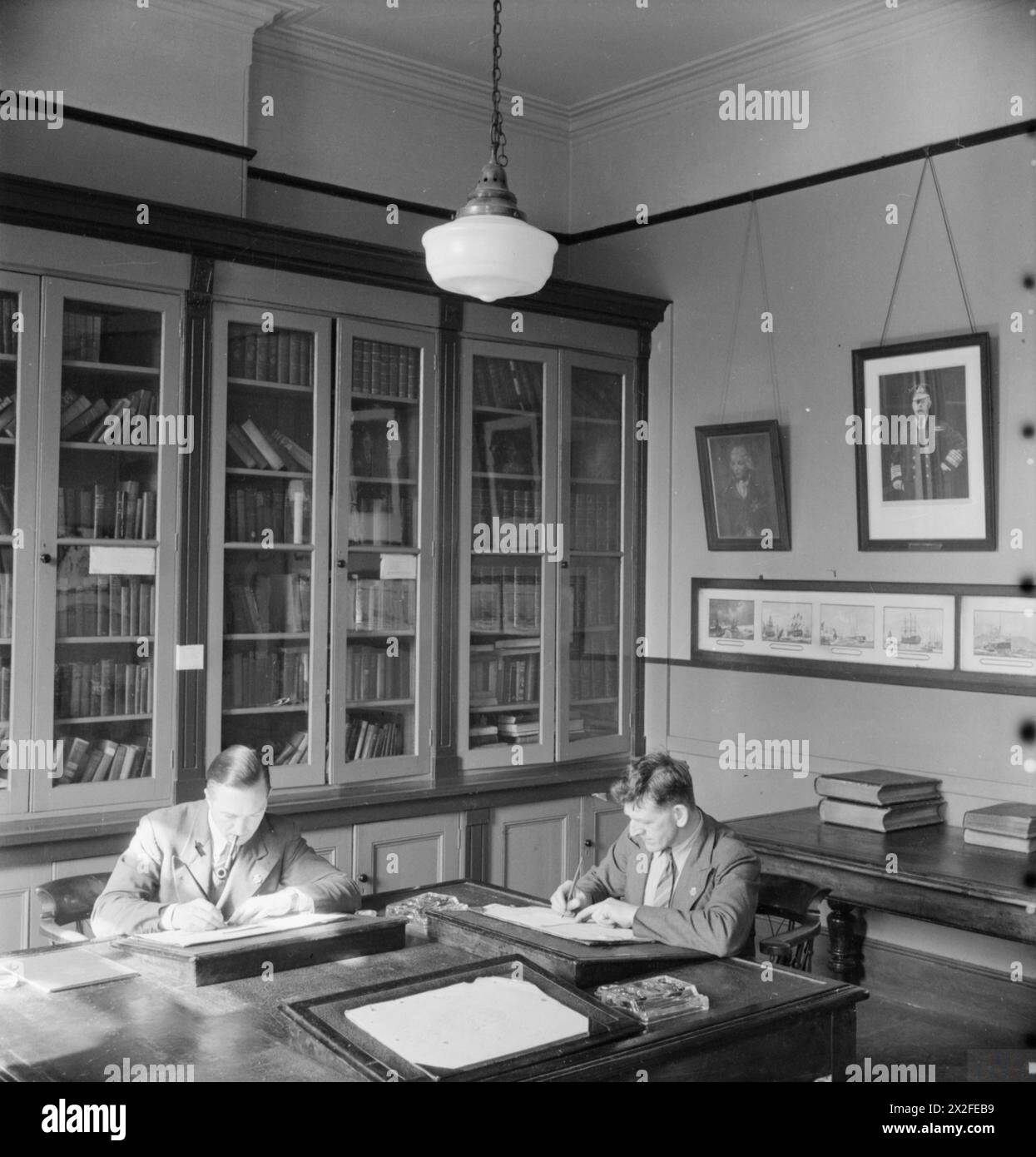 LONDON MERCHANT SEAMEN'S HOME ET RED ENSIGN CLUB, 1942 - George Lappin (à droite) et un autre marin marchand écrivent des lettres dans la paix et la tranquillité de la bibliothèque de la Merchant Seamen's Home et Red Ensign Club Merchant Navy Banque D'Images