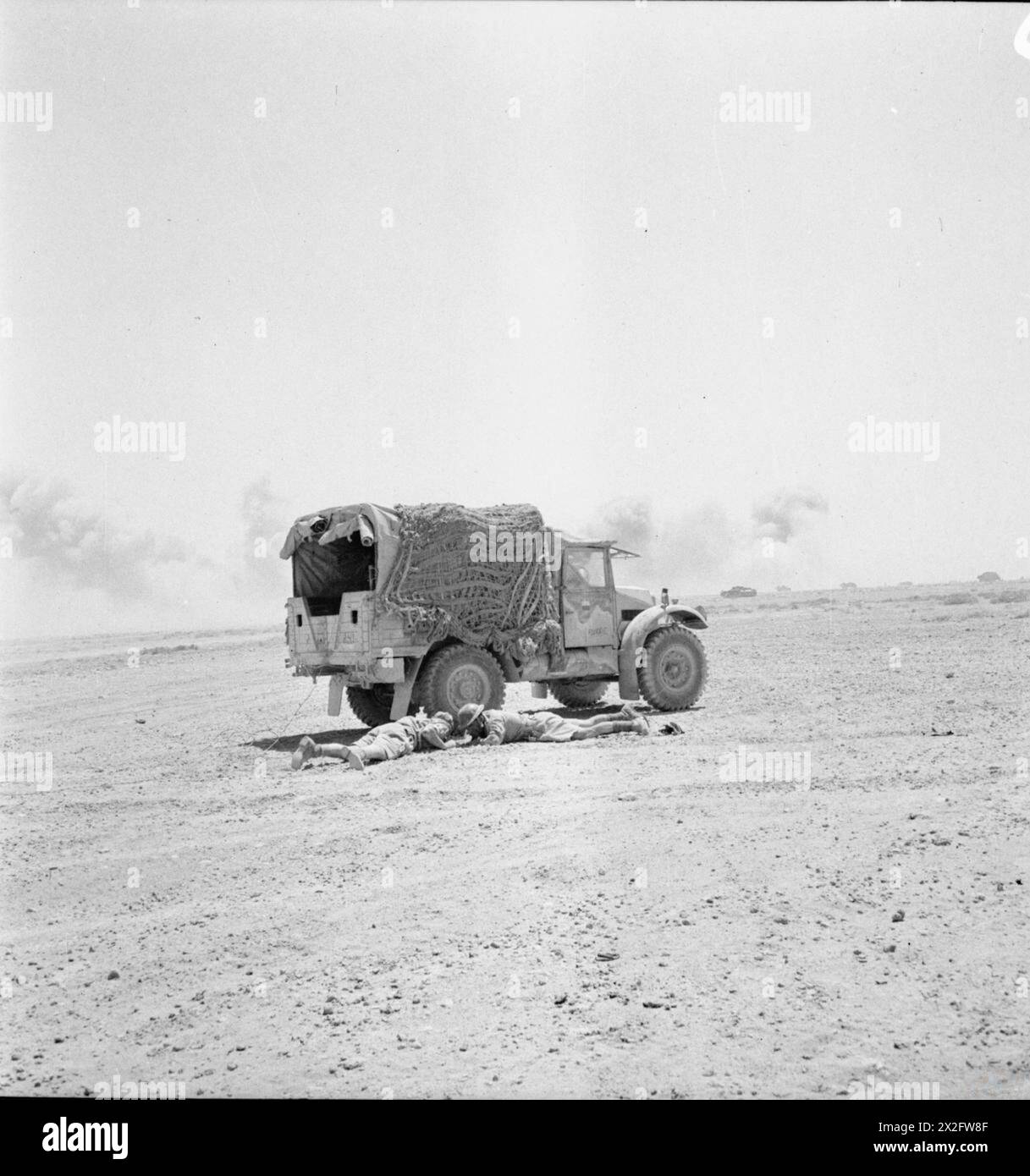 L'ARMÉE BRITANNIQUE EN AFRIQUE DU NORD 1942 - L'équipage d'un camion Morris-commercial C4 15cwt se met à l'abri lors d'un raid aérien ennemi dans le désert occidental, le 2 juin 1942 Banque D'Images
