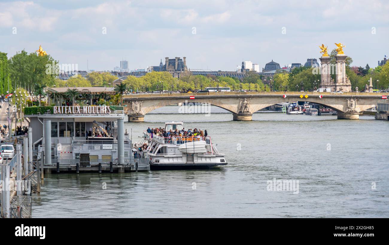 Quai des bateaux-mouches avec le pont Alexandre III en arrière-plan. Les bateaux-mouches sont des bateaux d'excursion parcourant la Seine à Paris Banque D'Images
