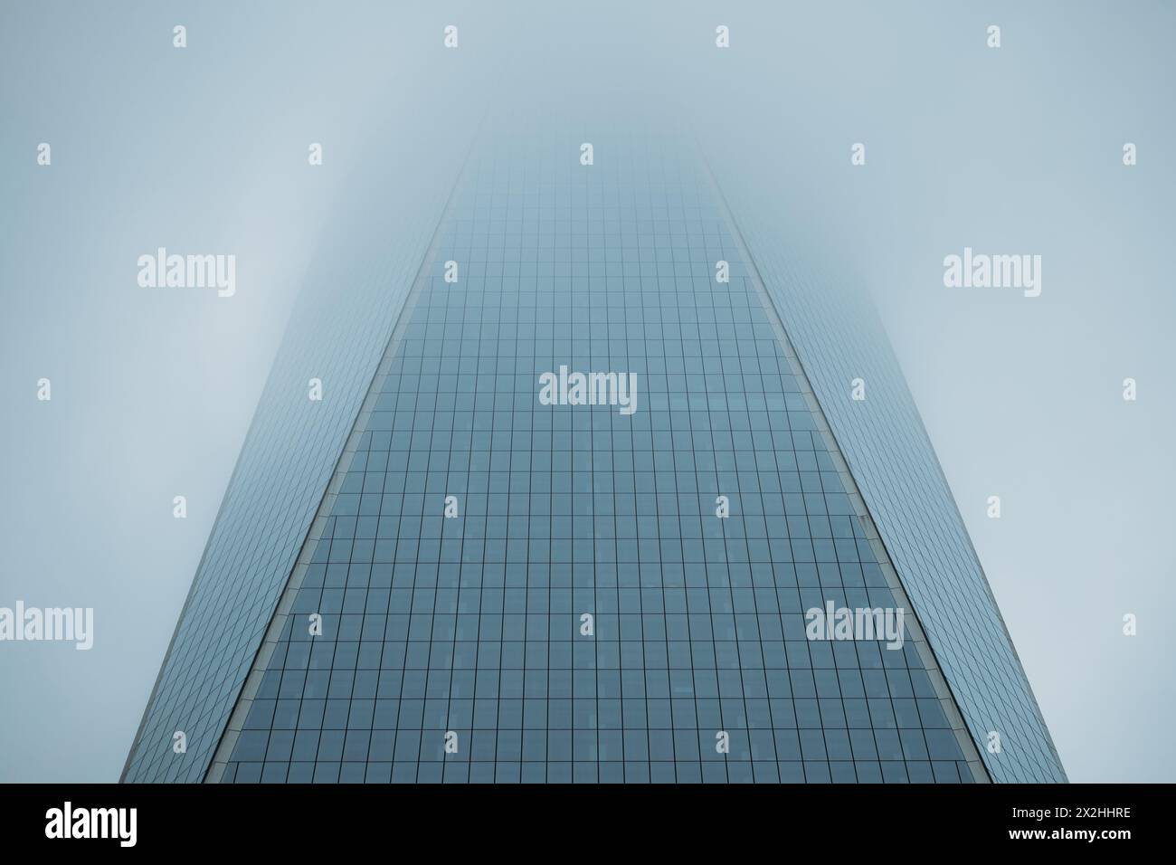Perspective de disparition du gratte-ciel en verre moderne contre le ciel nuageux Banque D'Images