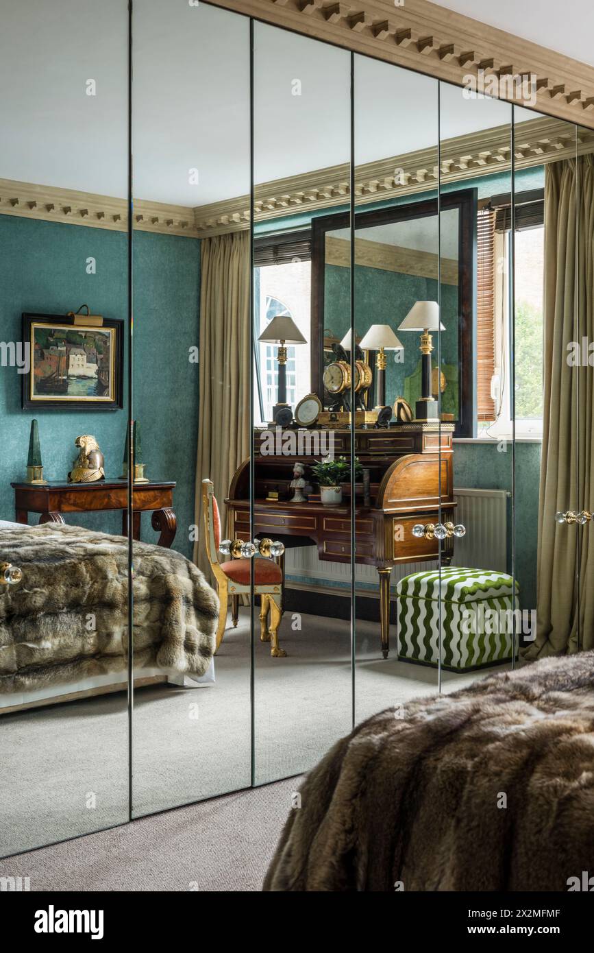 Armoire miroir reflétant la chambre dans l'appartement Chelsea, Londres Royaume-Uni Banque D'Images Armoire miroir reflétant la chambre dans l'appartement Chelsea, Londres Royaume-Uni Banque D'Images