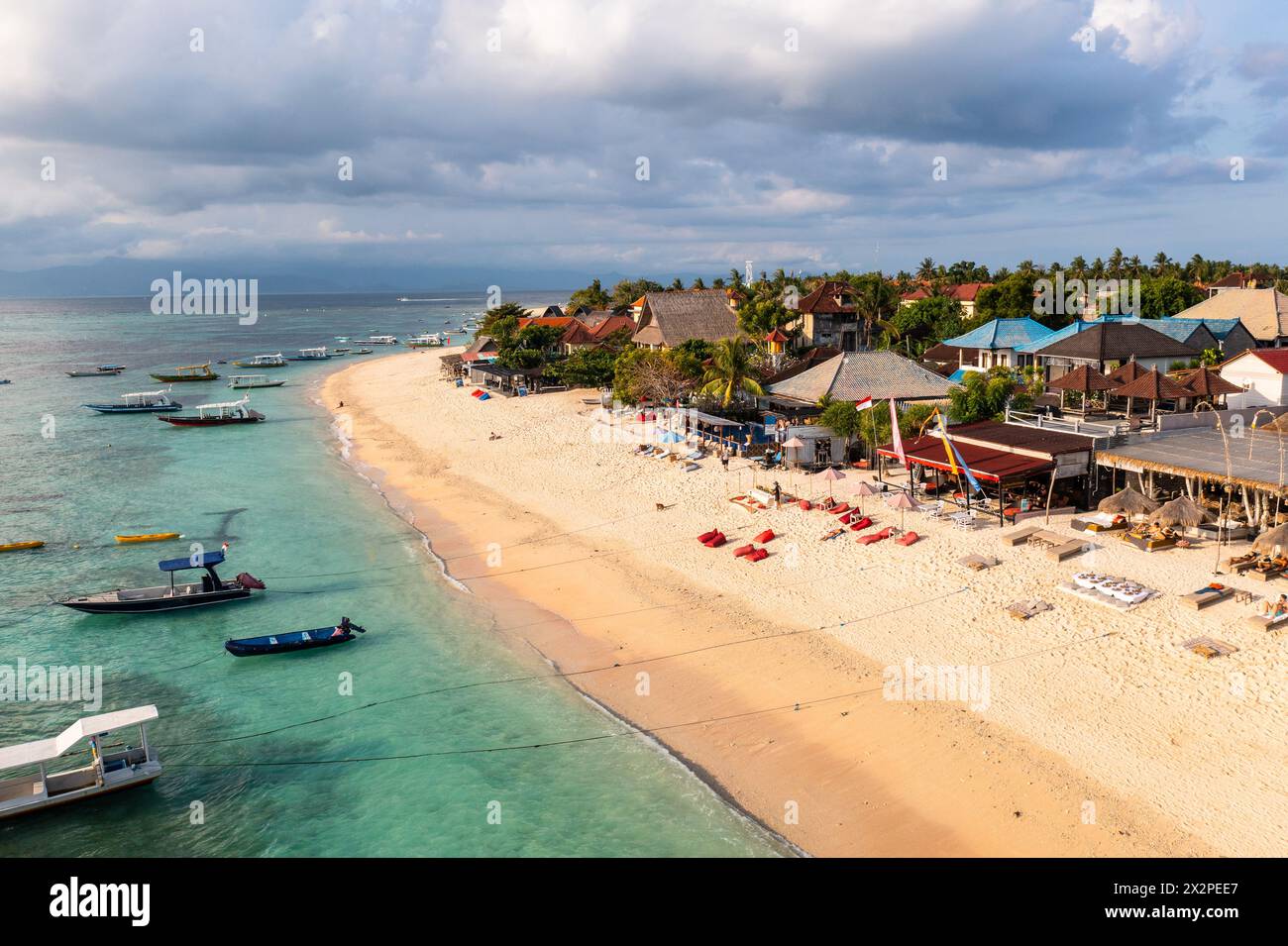 Nusa lembongan : vue aérienne par drone des touristes profitez de la plage Jungut Batu bordée de nouveaux clubs de plage et hôtels à Nusa Lembongan à Bali en Indonésie Banque D'Images