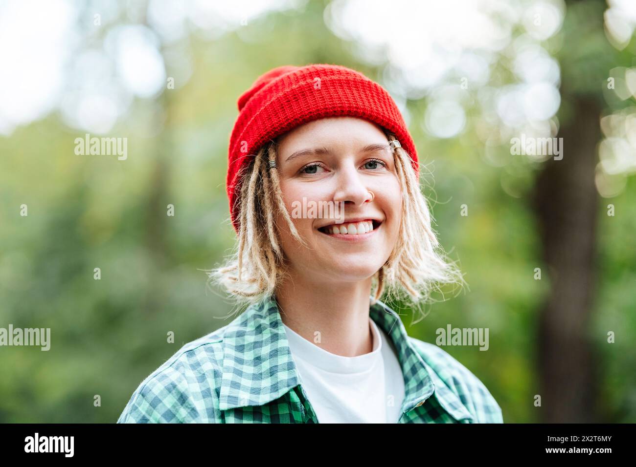 Heureuse jeune femme portant un bonnet en tricot rouge Banque D'Images
