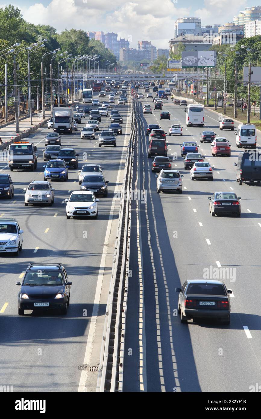 Voitures, camions, bus vont sur le pont dans la ville à la journée ensoleillée d'été. Des travaux sont en cours pour élargir les perspectives. Banque D'Images