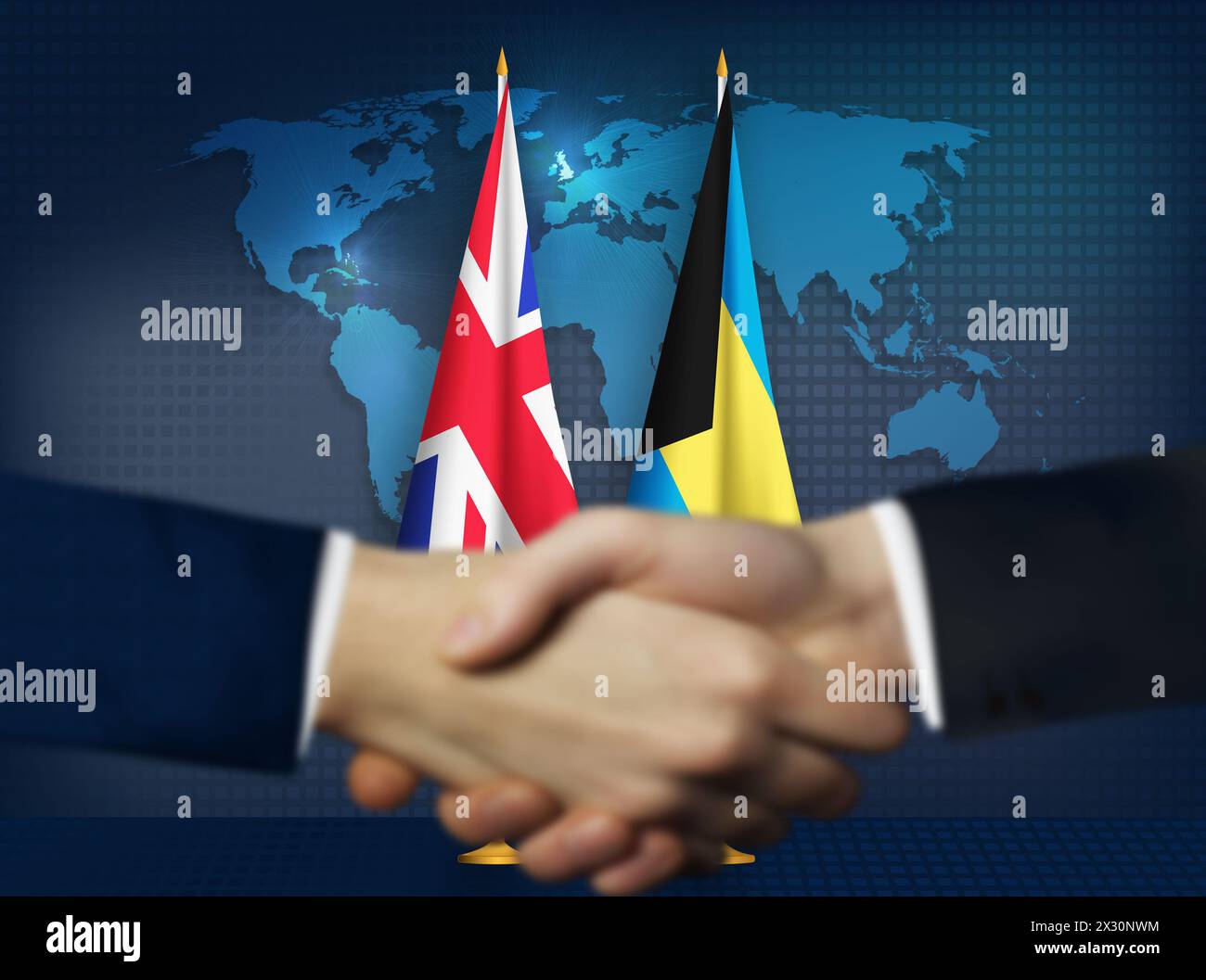 Deux personnes se serrant la main devant les drapeaux des Bahamas et du Royaume-Uni Banque D'Images