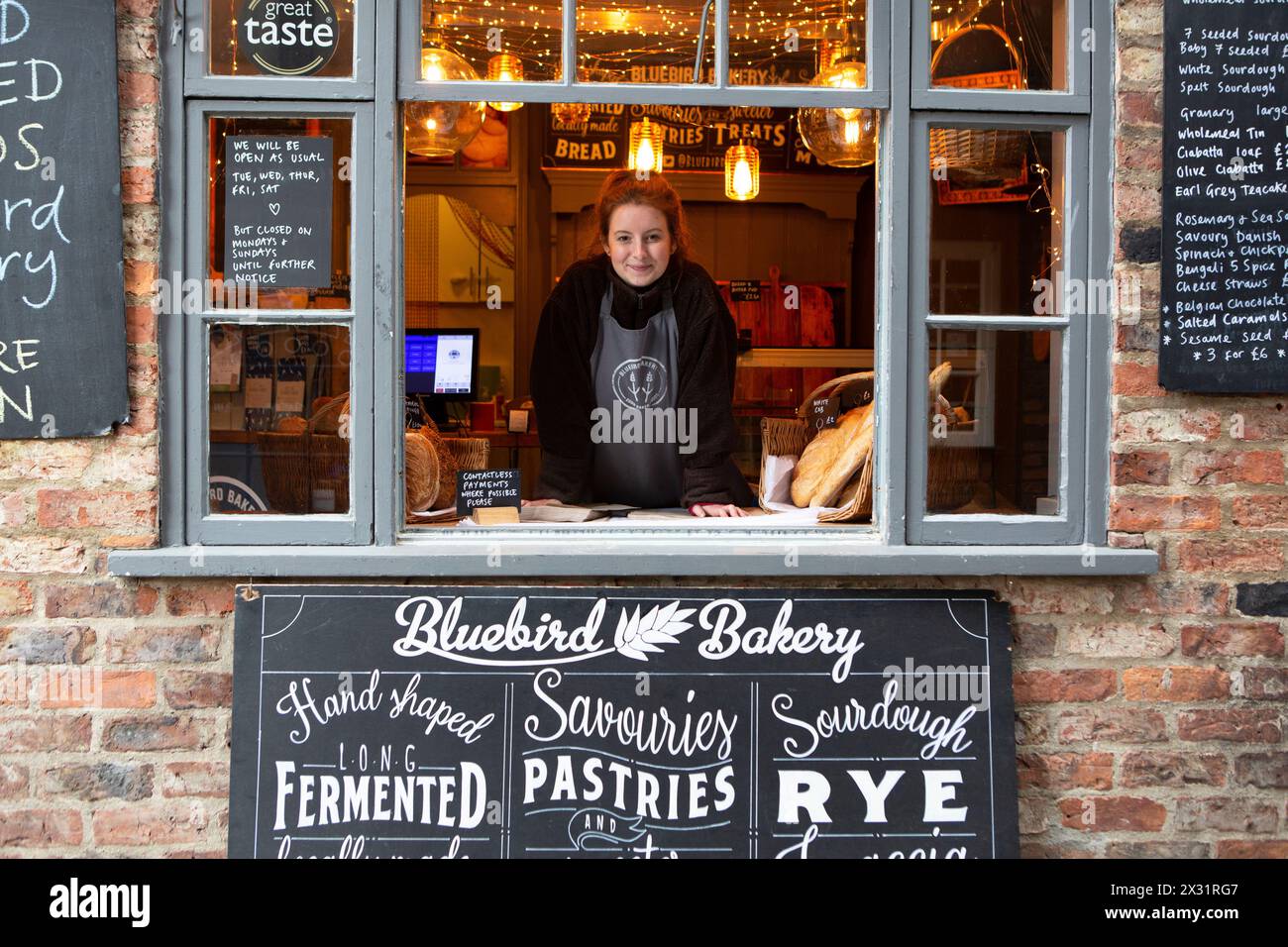 Maisie Waylett, 22 ans, une étudiante qui travaille à temps partiel à la trappe de service pour des plats à emporter à la boulangerie Bluebird à Little Shambles, dans le centre de la ville de York Banque D'Images
