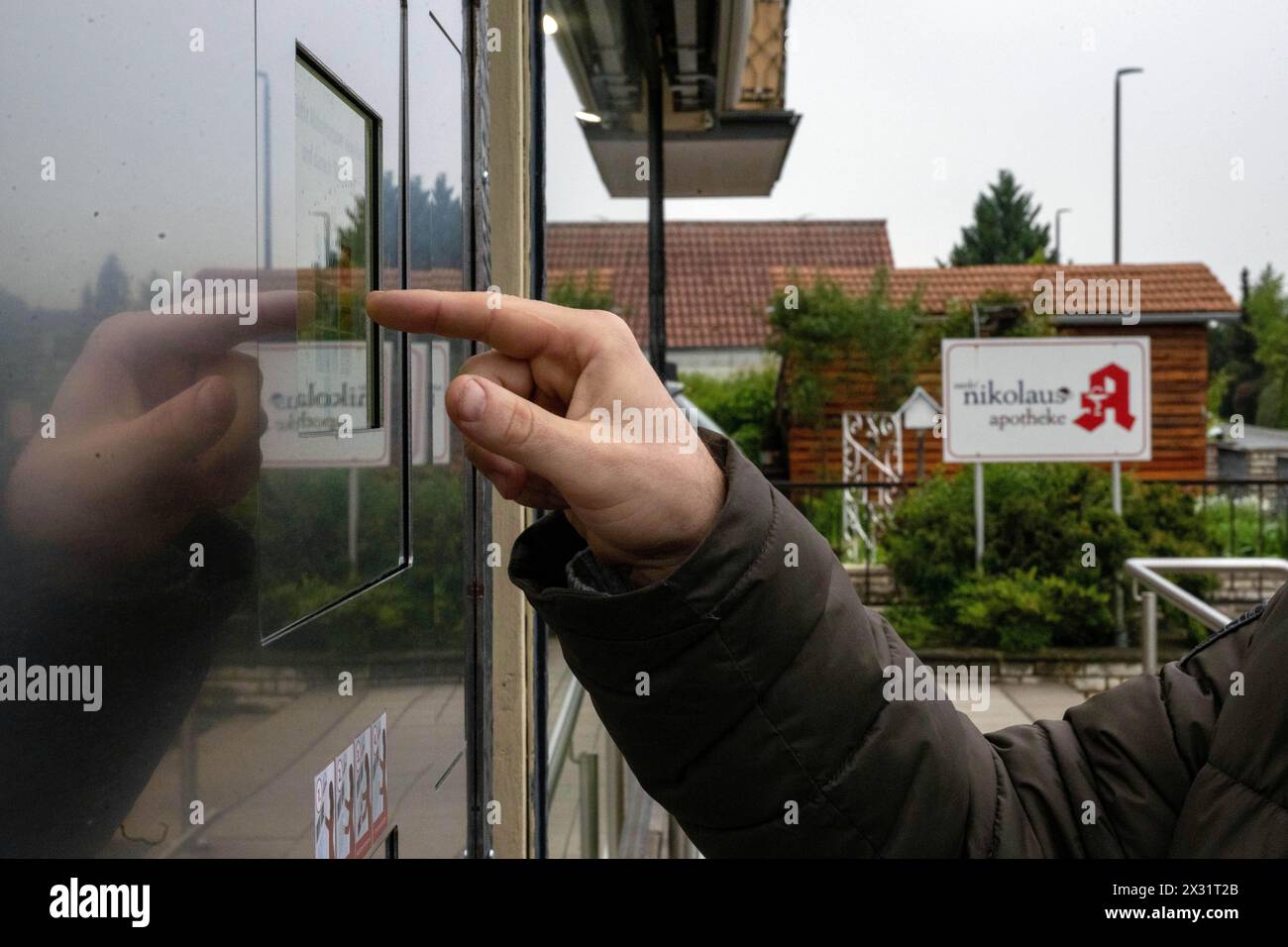 SYMBOL - 24 avril 2024, Bavière, Breitengüßbach : un homme tape un code numérique dans la machine de ramassage à l'extérieur d'une pharmacie pour récupérer les médicaments précommandés en dehors des heures d'ouverture. De plus en plus de pharmacies se tournent vers l’automatisation. Photo : Pia Bayer/dpa Banque D'Images