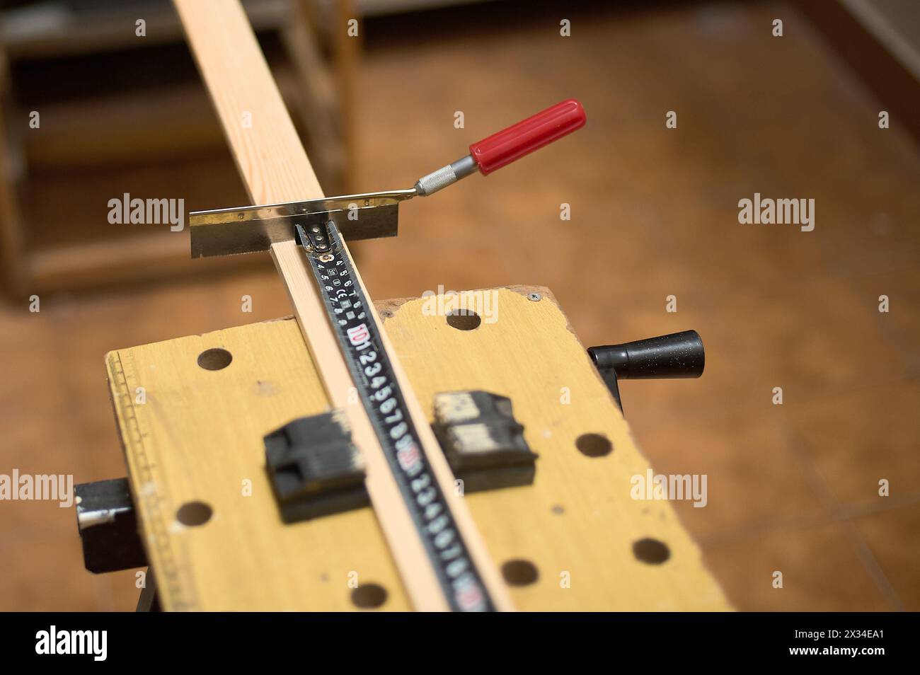 Image détaillée d'une scie et d'un ruban à mesurer dans un atelier de menuiserie, mettant en valeur la précision et l'habileté dans le travail manuel. Banque D'Images