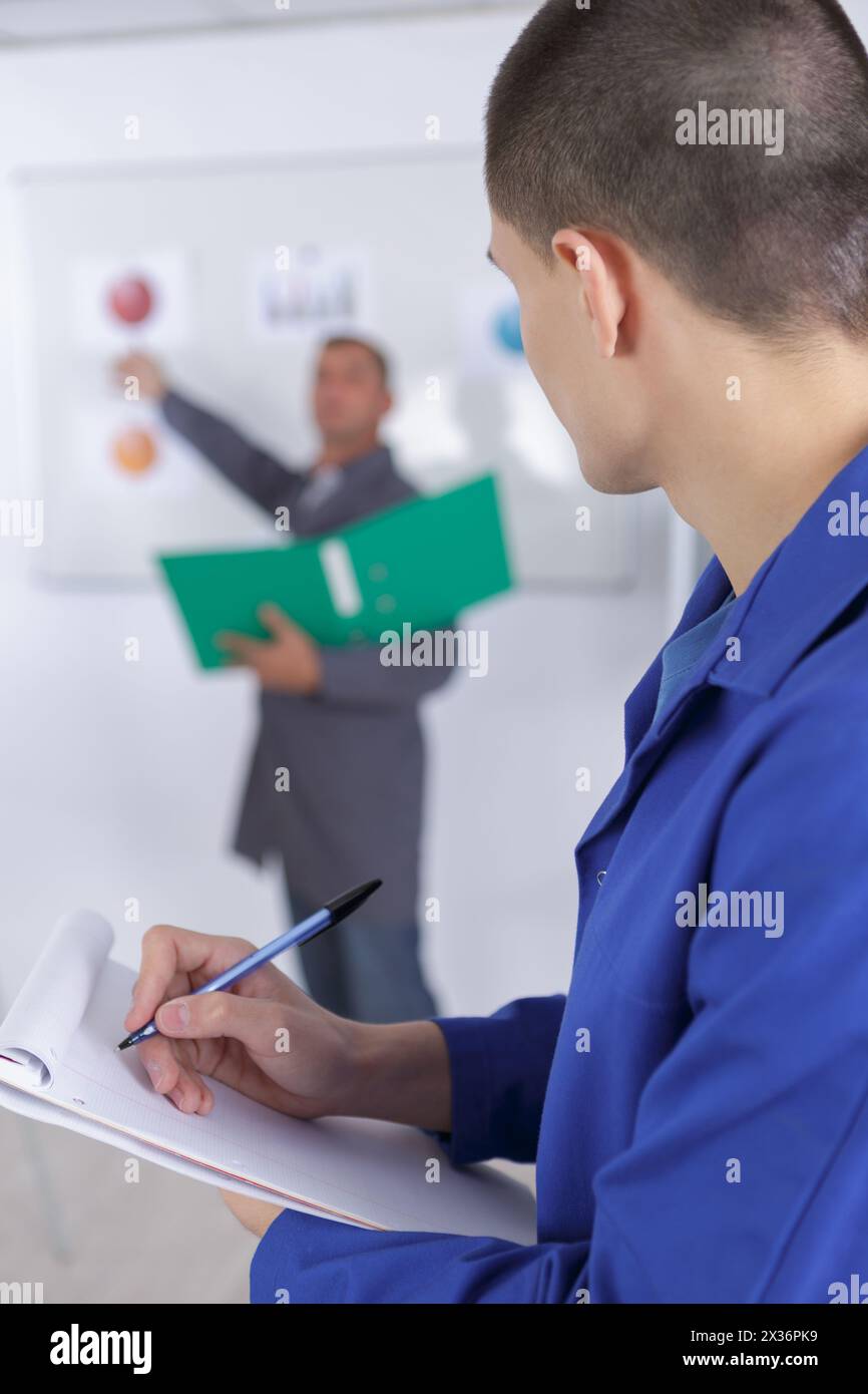 étudiant motivé prenant des notes en classe Banque D'Images