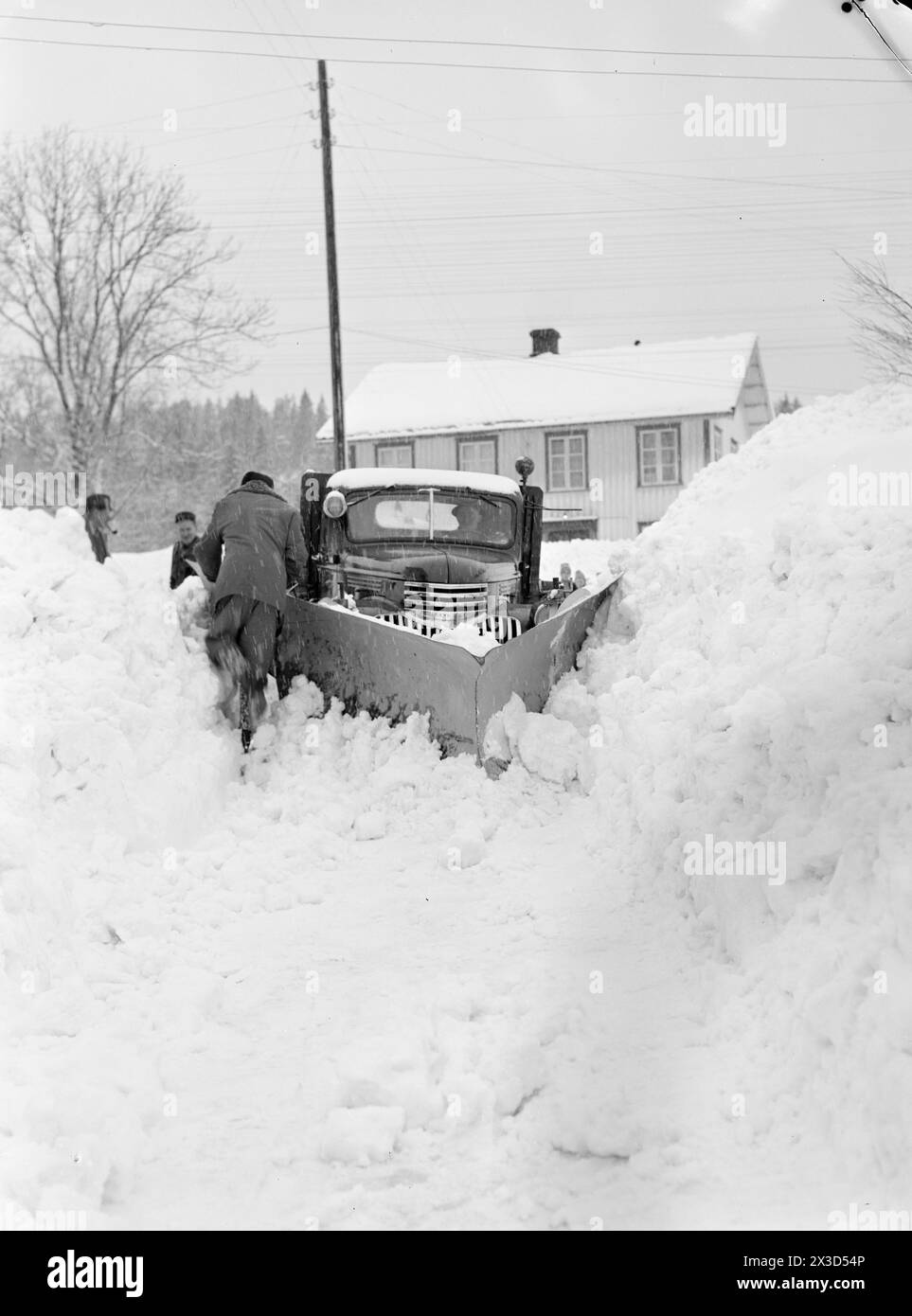 Réel 05- 1951 : le sud de la Norvège est couvert de neige. Quatre-cinq mètres de haut des bords de charrue le long des routes, la neige est si haute que vous pouvez facilement sortir du deuxième étage et les gens doivent constamment grimper sur les toits pour dégager la neige de là.photo : Arne Kjus / Aktuell / NTB ***la photo n'est pas traitée par image *** le texte de cette image est traduit automatiquement Banque D'Images