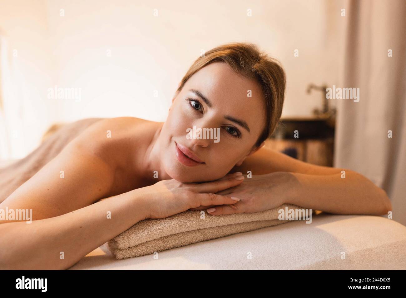 Belle femme se détend pendant le massage du dos. Femme heureuse appréciant le massage du dos pendant le week-end de temps sur le centre de spa Banque D'Images