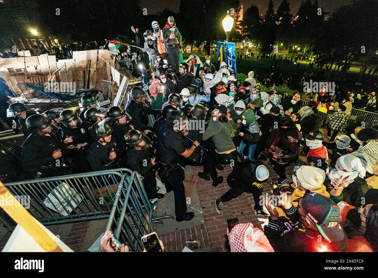 Les officiers du LAPD s'infiltrent à l'extrémité ouest du campement pro-palestinien à UCLA, mais se retirent peu après en raison du nombre de manifestants par lesquels ils sont encerclés. Banque D'Images