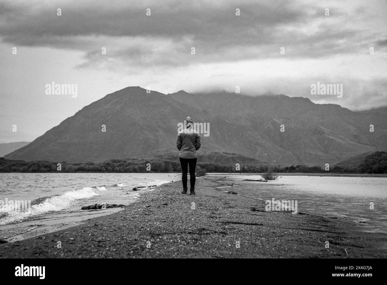 Personne solitaire se tient sur la plage du lac Hawea, Nouvelle-Zélande Banque D'Images