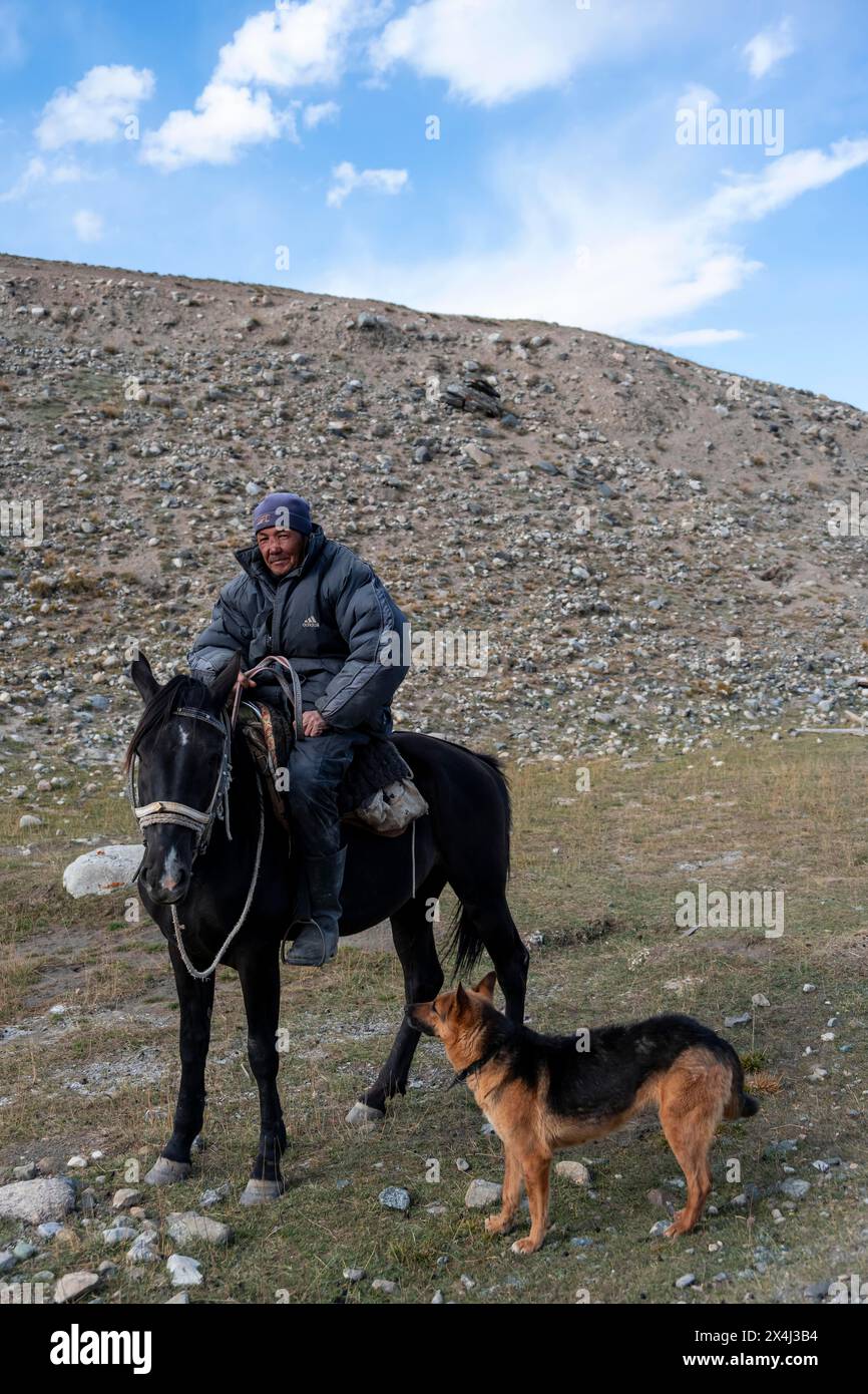 Vie nomade sur un plateau, berger à cheval avec chien, montagnes Tian Shan, Jety Oguz, Kirghizistan Banque D'Images