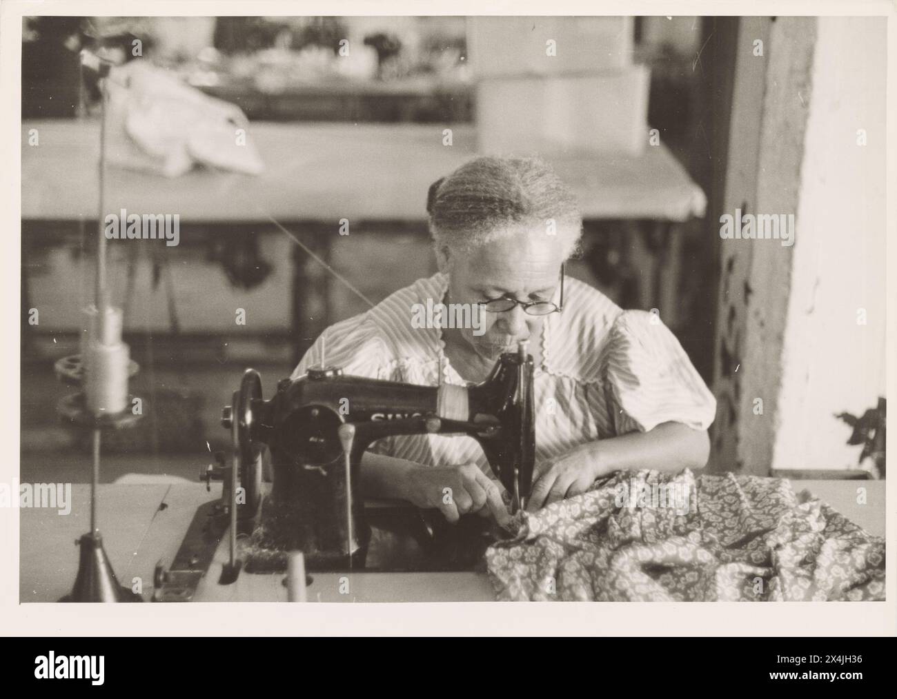 Une femme portoricaine âgée qui utilise une machine à coudre, dans l'usine de couture des Everglades, San Juan, Porto Rico. Janvier 1942. Photographie historique vintage de la collection de l'administration de la sécurité du gouvernement des États-Unis des années 1940 Crédit photo : Jack Delano. Banque D'Images