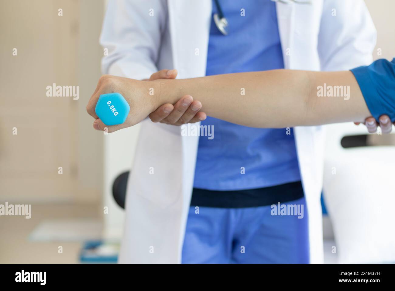 médecin vérifie les blessures musculaires et en utilisant des haltères test blessure et aide également à la thérapie physique renforcer les muscles parce que la thérapie physique Banque D'Images
