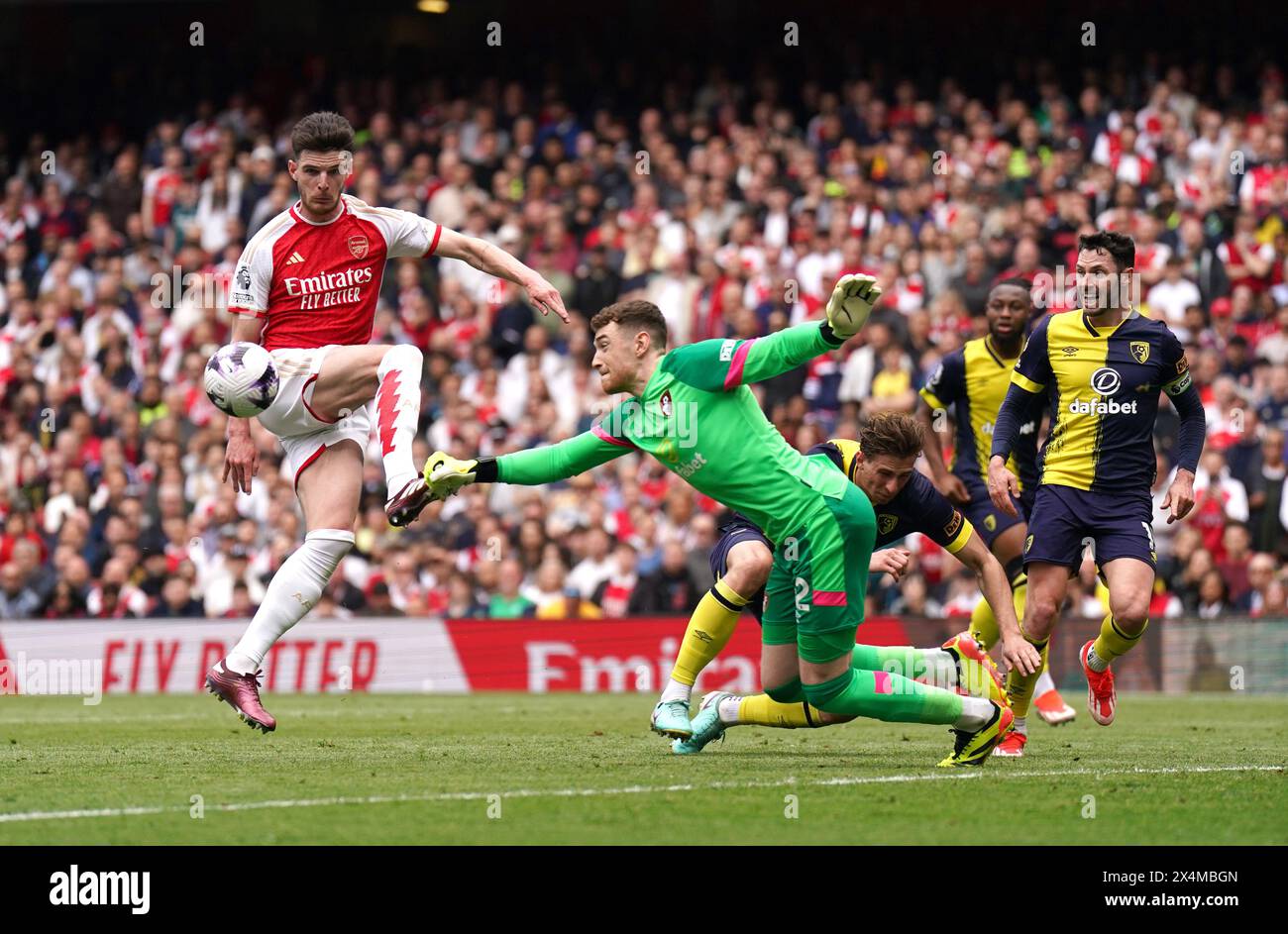 Declan Rice d'Arsenal et Mark travers, gardien de Bournemouth, s'affrontent pour le ballon lors du match de premier League à l'Emirates Stadium de Londres. Date de la photo : samedi 4 mai 2024. Banque D'Images