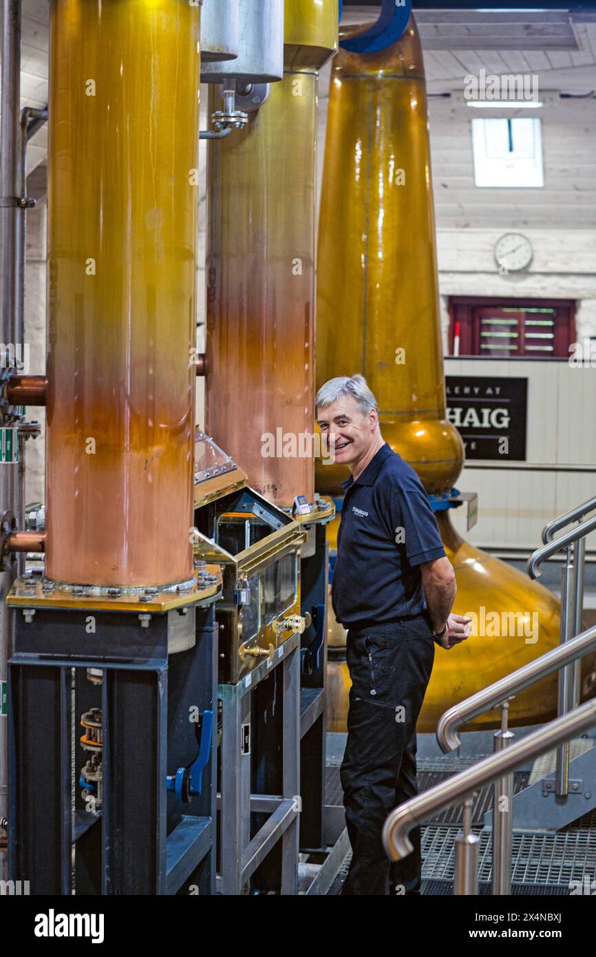L'homme STILL vérifie les taux d'alcool dans la distillerie Spirit Safe de Torabhaig sur l'île de Skye, en Écosse Banque D'Images