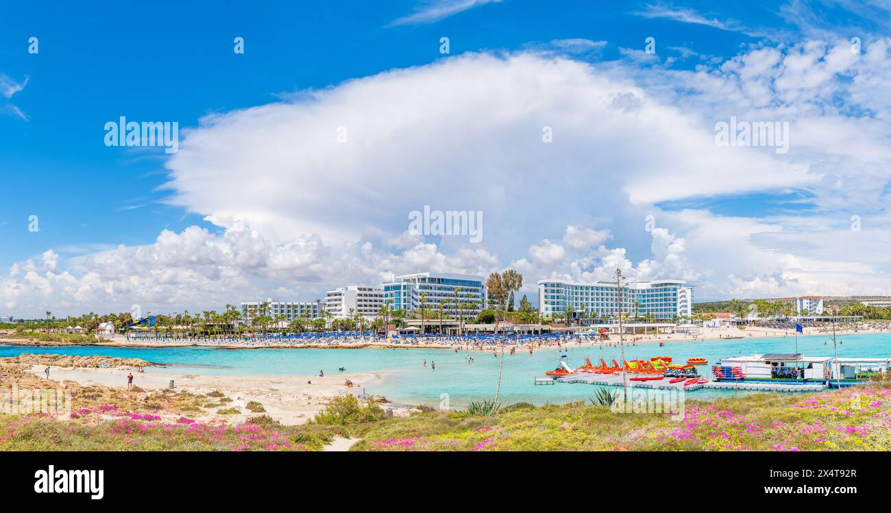 Découvrez la plage immaculée de Nissi à Chypre, un paradis au sable blanc et aux eaux turquoises, parfait pour la détente, les sports nautiques et les vacances en famille Banque D'Images