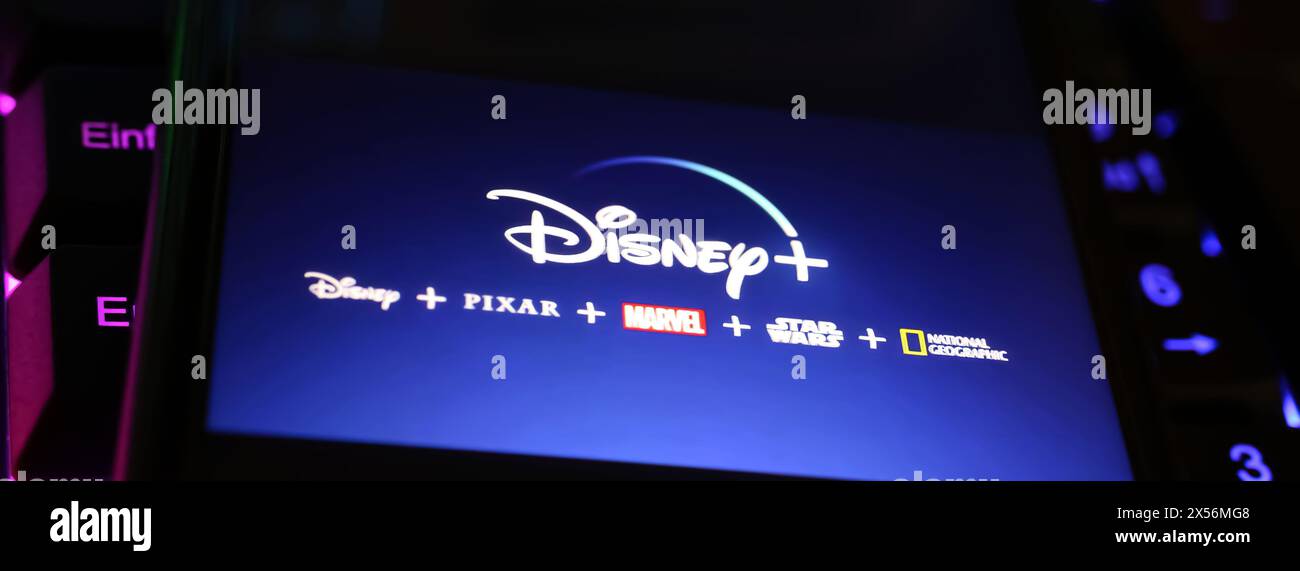 Viersen, Allemagne - 1er mai. 2024 : gros plan de smartphone avec lettrage logo des chaînes de service de streaming Disney plus sur clavier d'ordinateur Banque D'Images