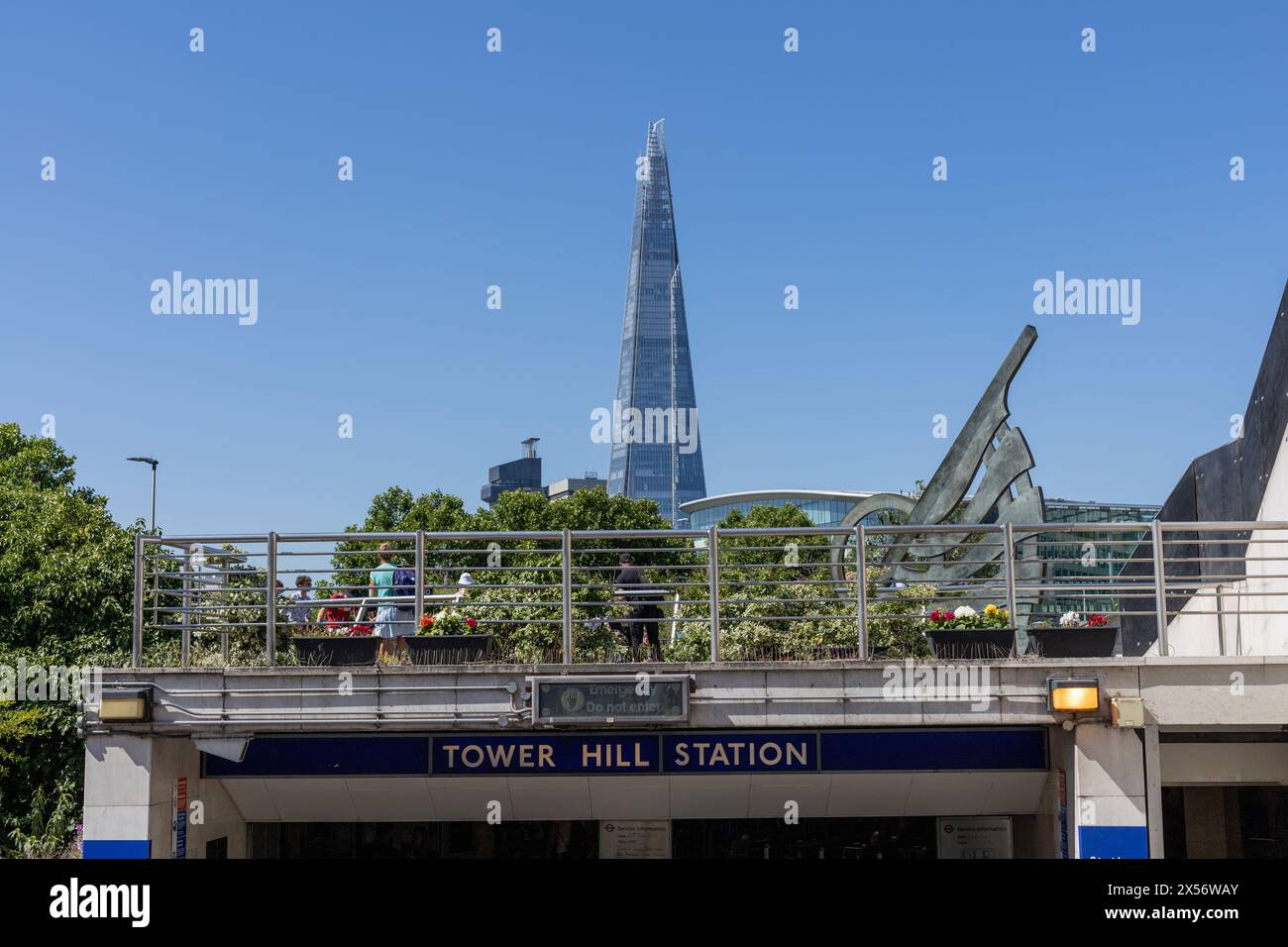 Londres, Angleterre - 19 juin 2022 : entrée à la station de métro Tower Hill avec plate-forme d'observation avec des gens sur le dessus. Grand bâtiment l'éclat visible à l'arrière Banque D'Images