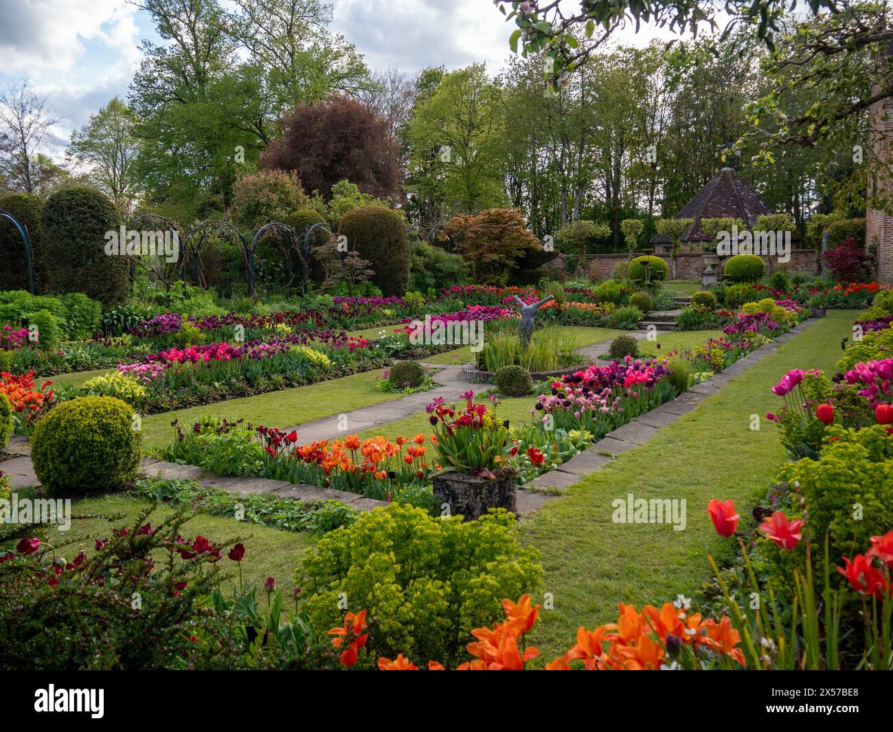 Chenies Manor jardin encastré avec tulipes colorées en pleine floraison. Fleurs oranges, roses, violettes en fin d'après-midi soleil. Banque D'Images