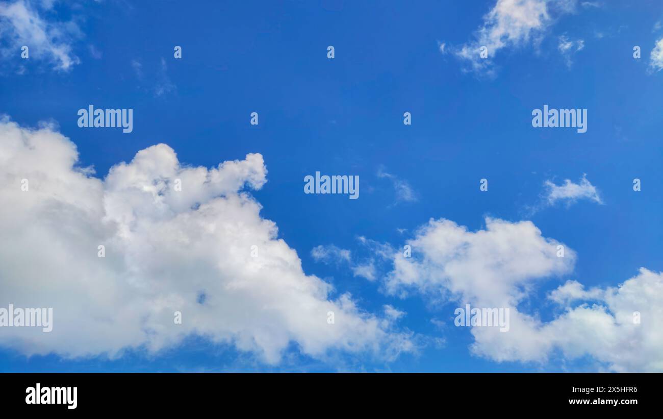 Paysage de nuages fascinant, avec des nuages de cumulus blancs pelucheux dérivant à travers un ciel bleu éclatant Banque D'Images