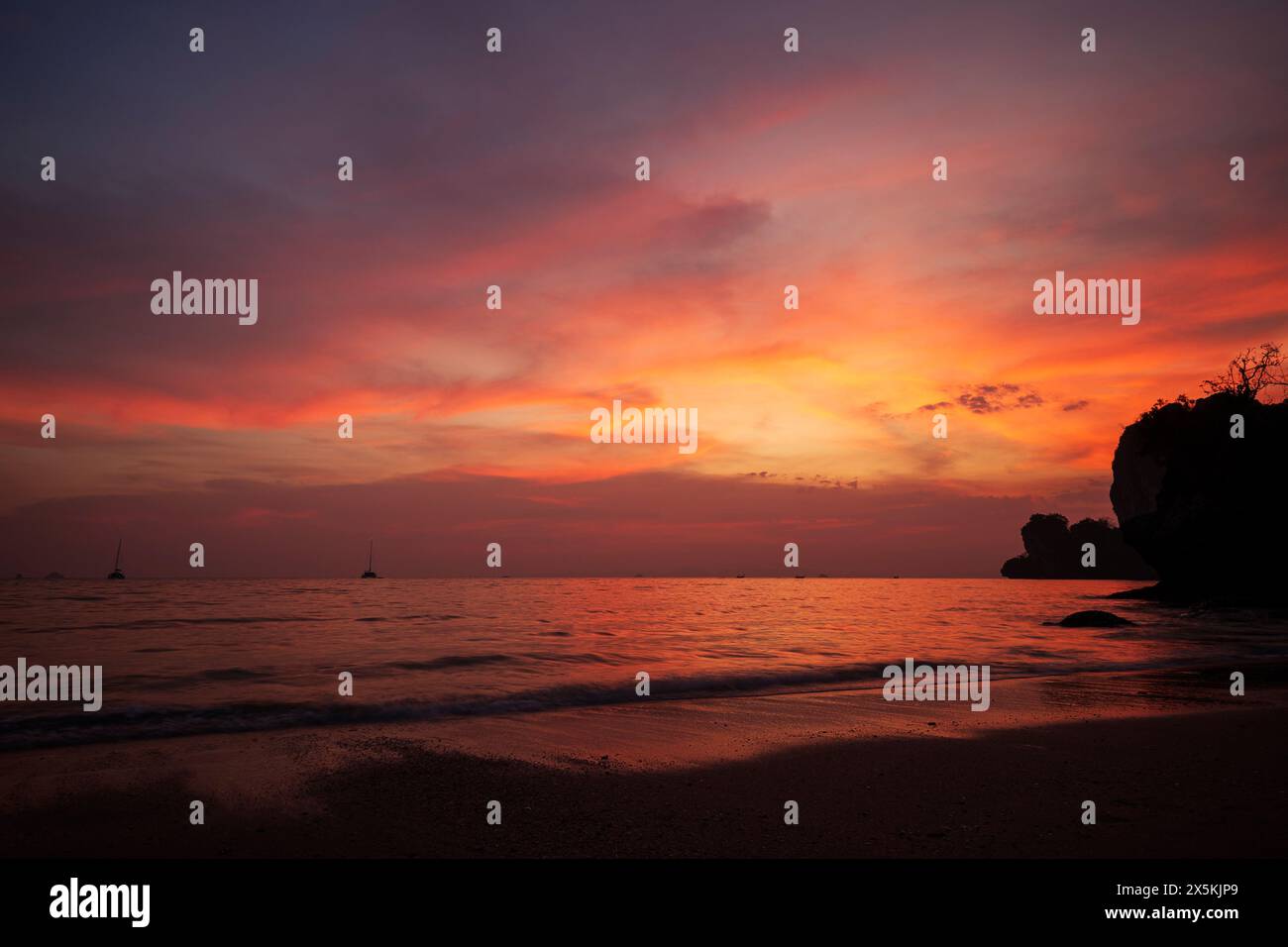 Beau paysage de mer, plage et ciel coloré pendant le coucher du soleil à la plage de Railay West à Railay, Krabi, Thaïlande. Banque D'Images