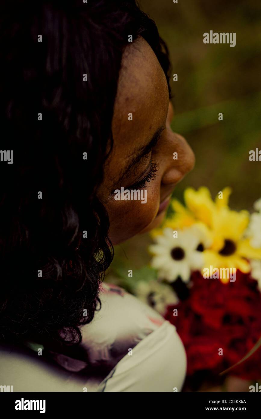 Nigeria, Etat du Delta, gros plan de femme et de fleurs en plein air Banque D'Images